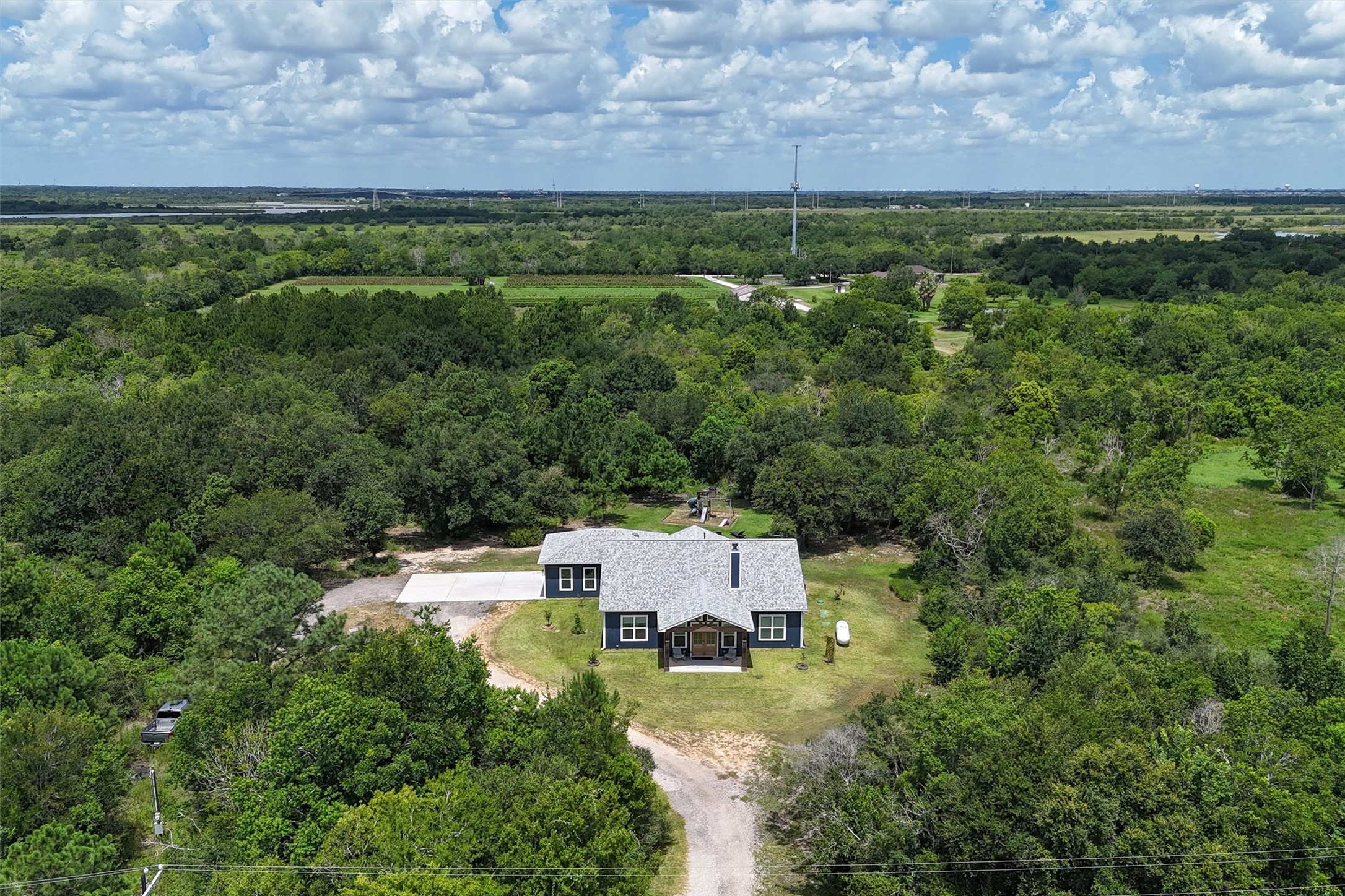 Overhead view of the front of the home. Primary backs up to an orchard.
