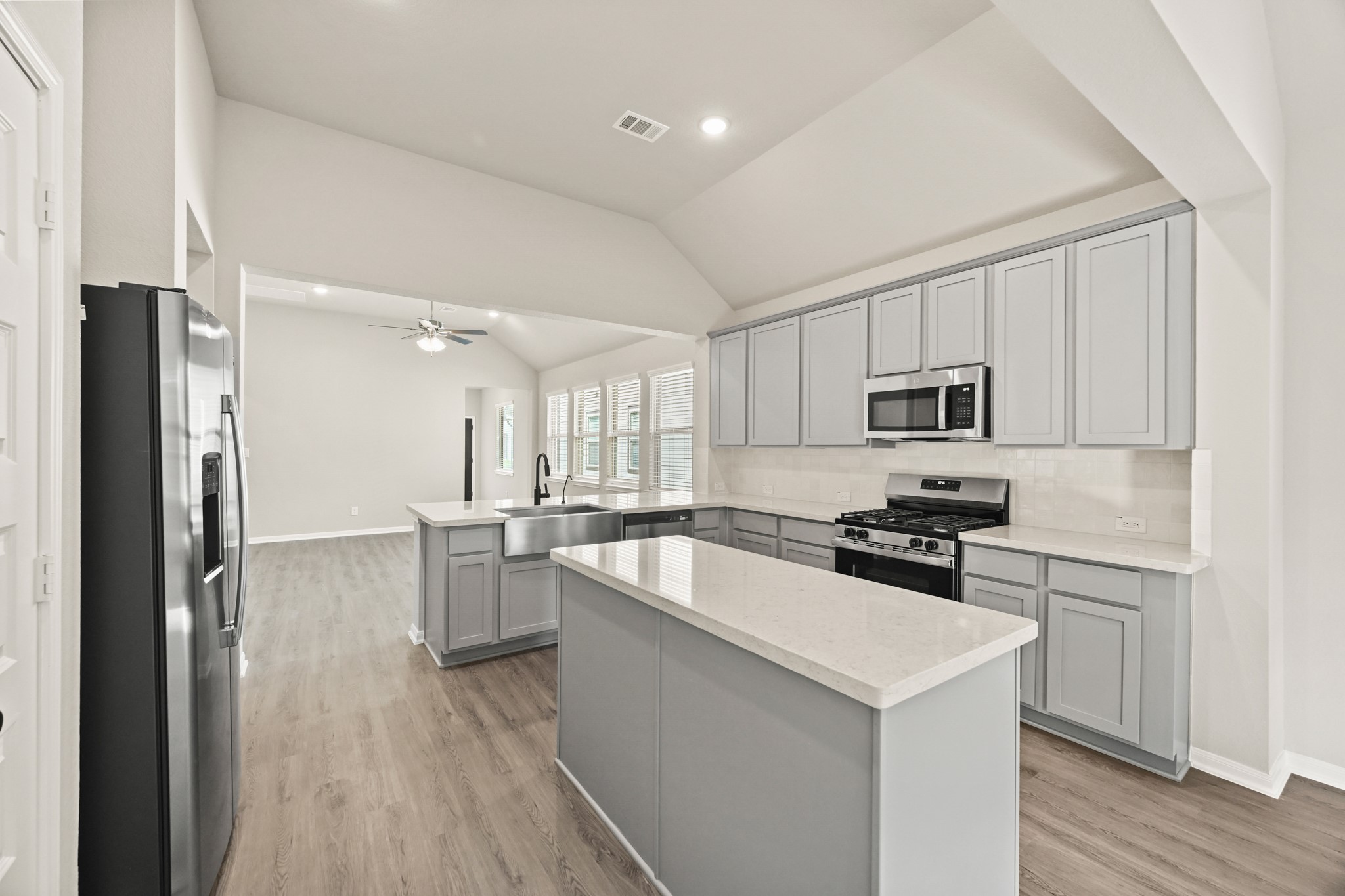 Stylish kitchen with lowered bar top and central island (*Photo not of actual home and used for illustration purposes only.) Stylish kitchen with lowered bar top and central island (*Photo not of actual home and used for illustration purposes only.)