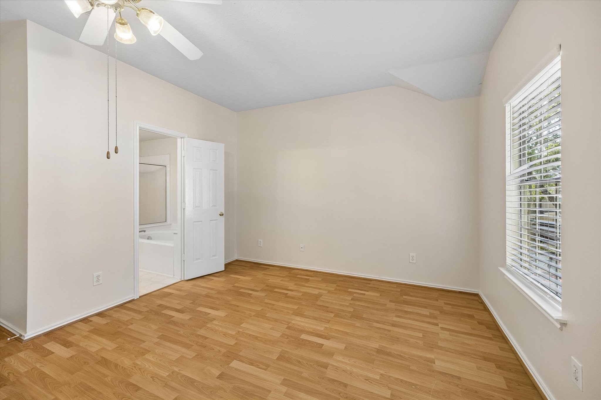 Primary bathroom suite is through the door.