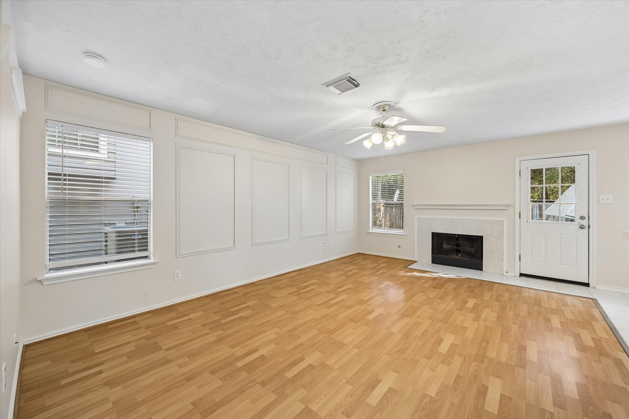 Large space with view of the charming fireplace and outdoors.