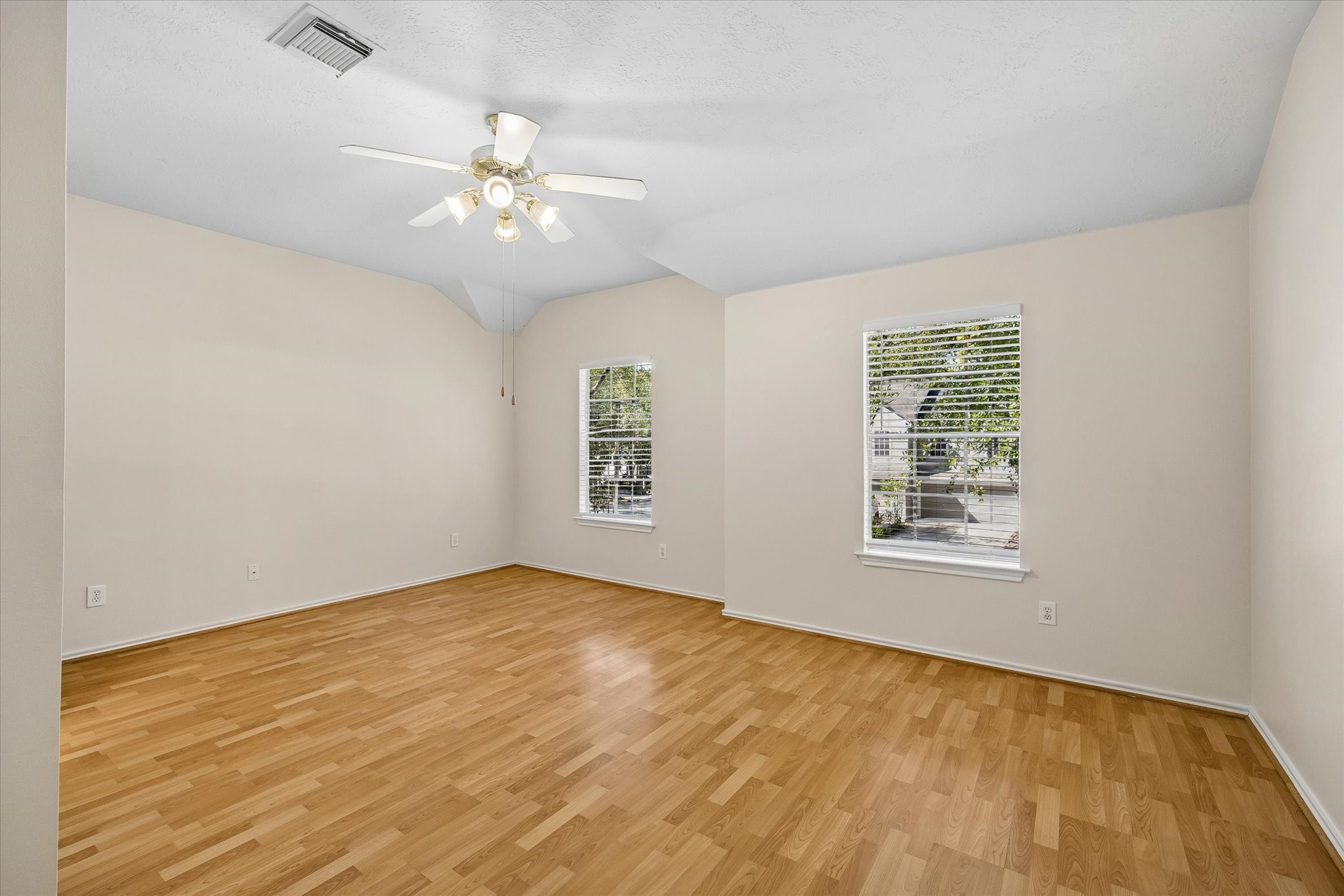 The primary bedroom is large and can accommodate a desk and wide dresser, if needed.