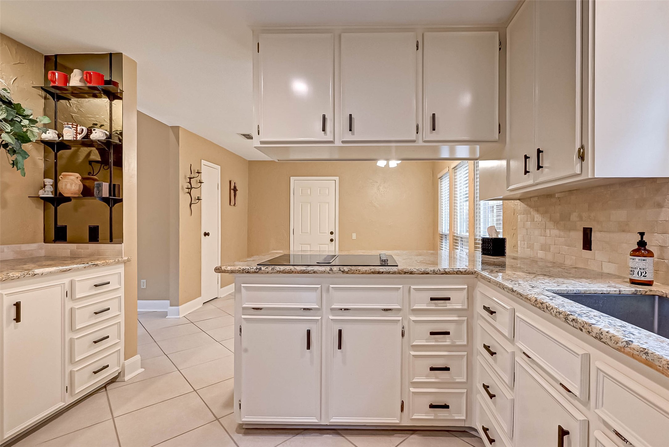 Lots of kitchen cabinets and the breakfast room leads to the garage,