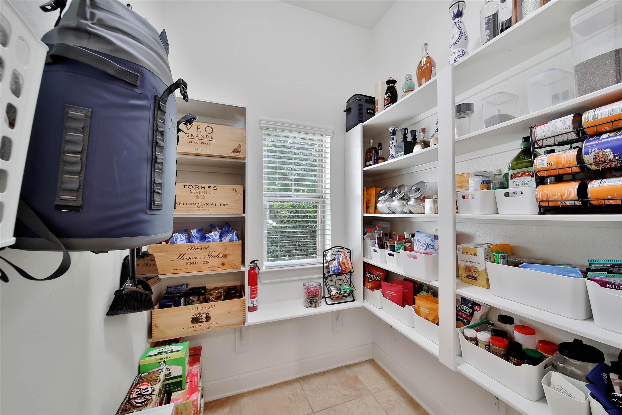 The large walk-in pantry offers exceptional storage space and keeps the kitchen organized and clutter-free.