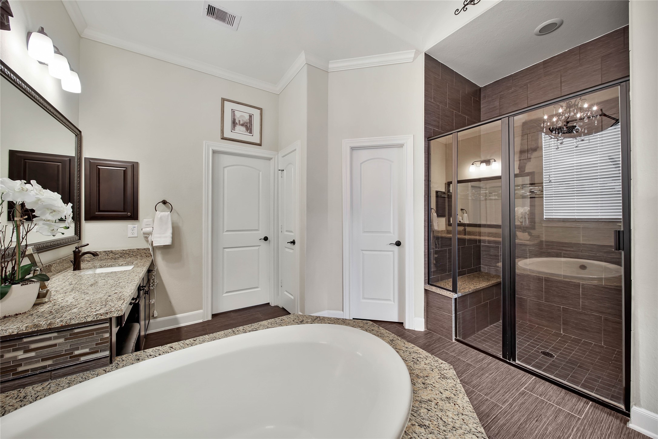 The spacious primary bath includes a separate shower with a built-in bench, offering both comfort and convenience in this relaxing retreat.