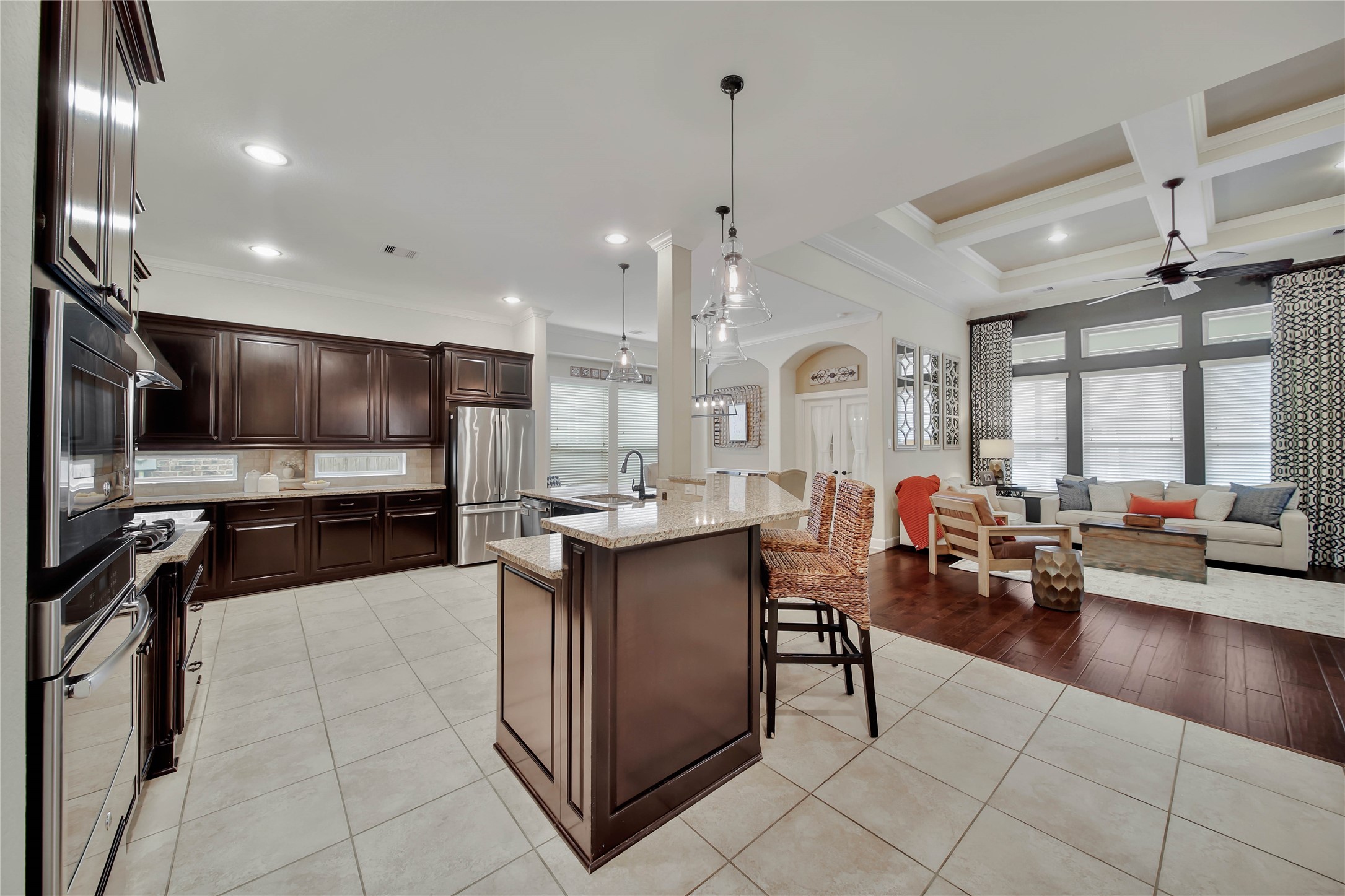 The kitchen opens seamlessly to the living room, creating a spacious and inviting gathering area.