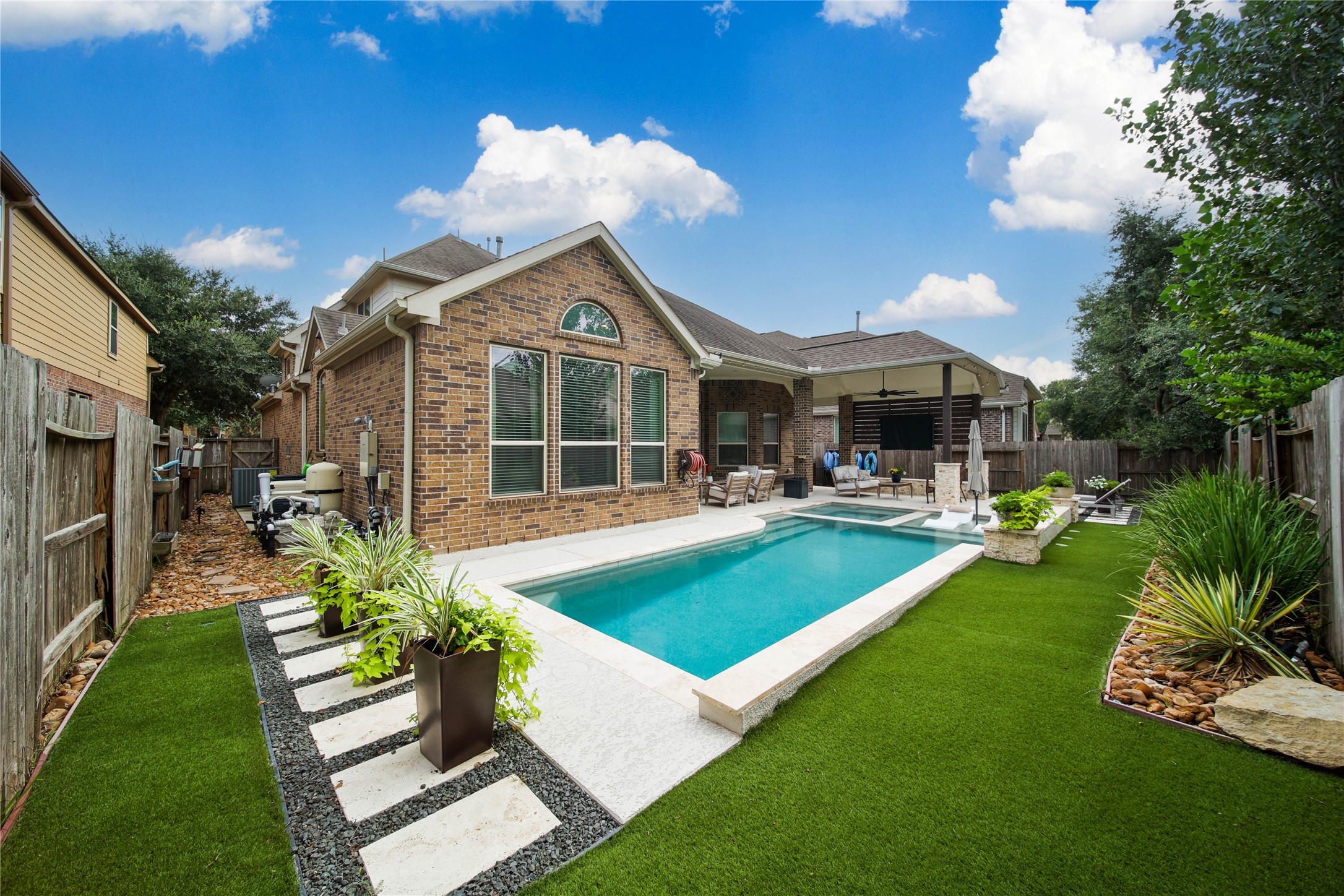 Designed for entertaining and everyday relaxation, this home offers outdoor living that everyone will enjoy. From the covered patio and inviting gathering spaces to the pool and spa, the backyard is the perfect place to unwind and make lasting memories. The turf is an easy-care alternative that looks great year-round, providing a beautiful and low-maintenance outdoor space.