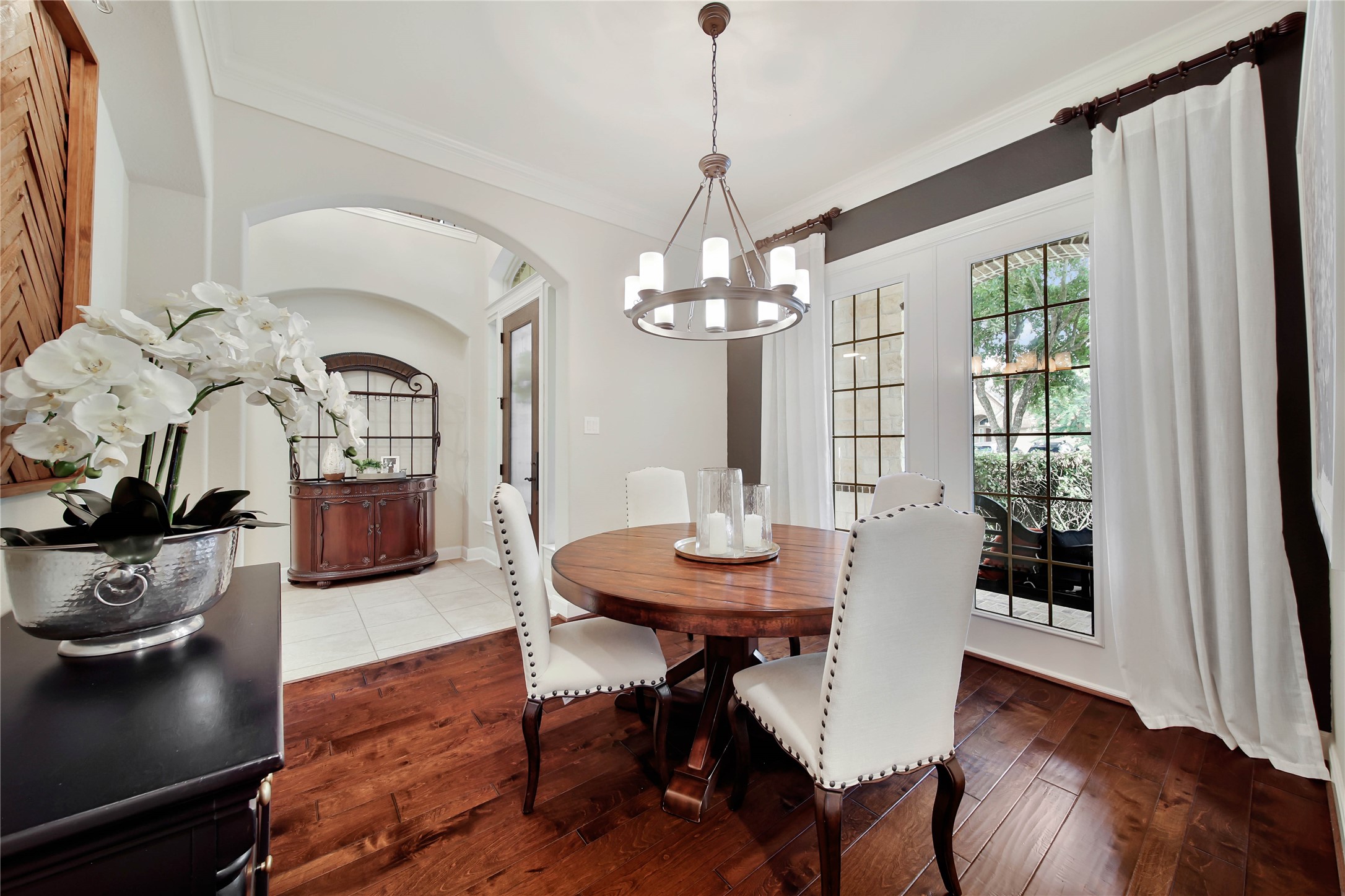 The elegant living room showcases rich wood floors, creating a warm and inviting atmosphere.
