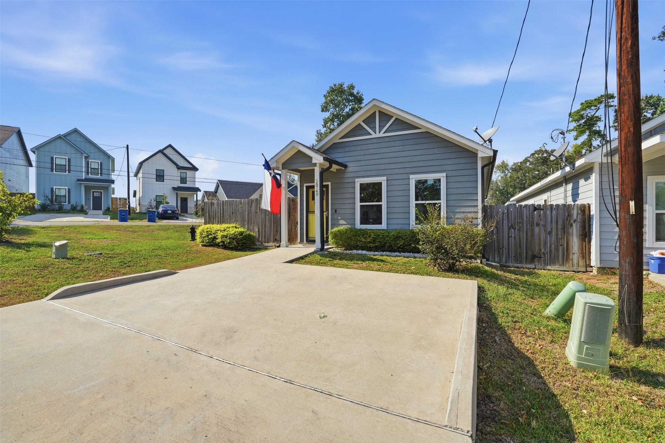 Charming single-story home with a welcoming front porch, nestled in a peaceful neighborhood. Features a well-maintained exterior and a spacious concrete driveway.