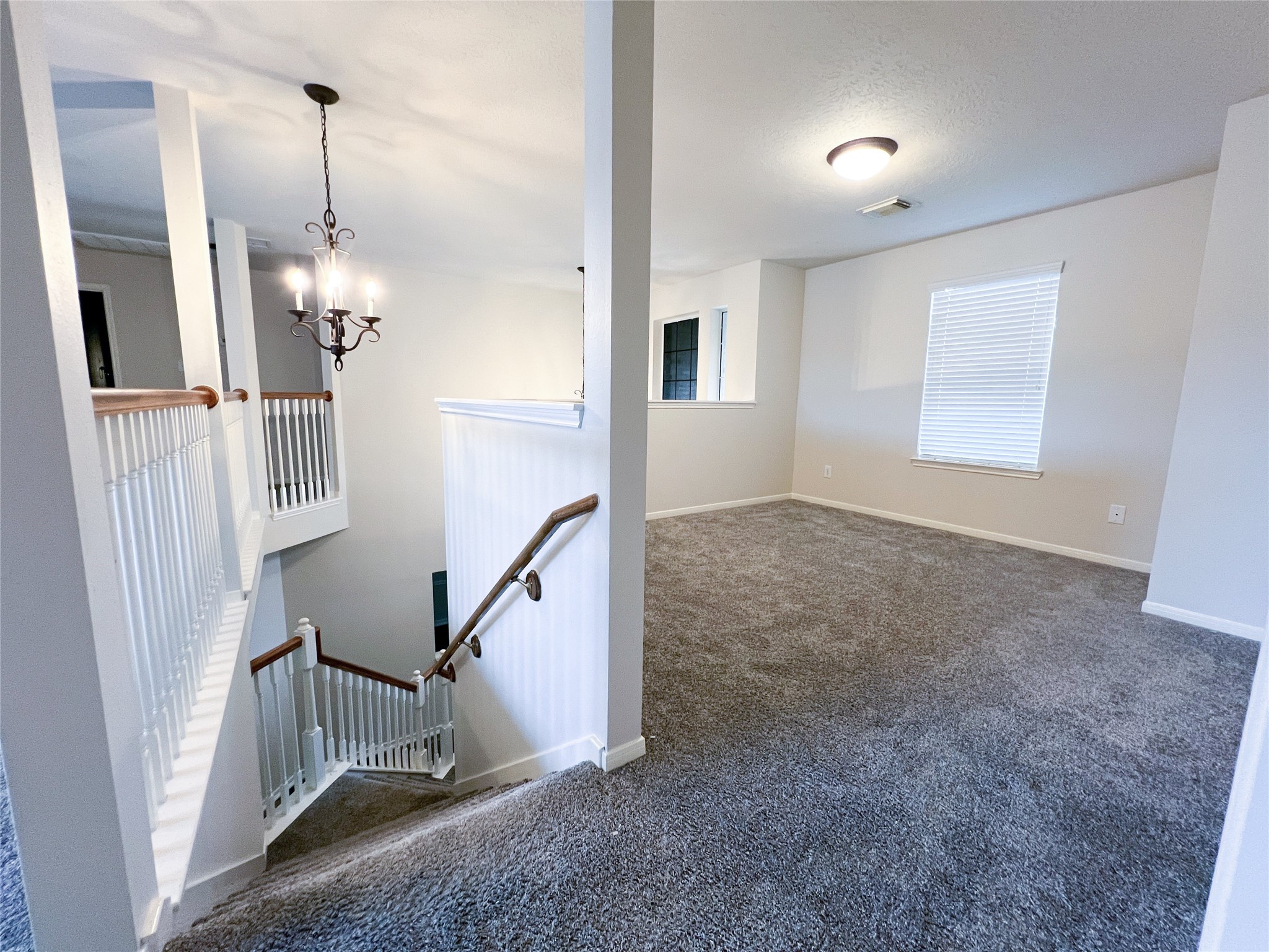 Upstairs, enjoy a spacious game room filled with natural light, perfect for entertainment and relaxation.