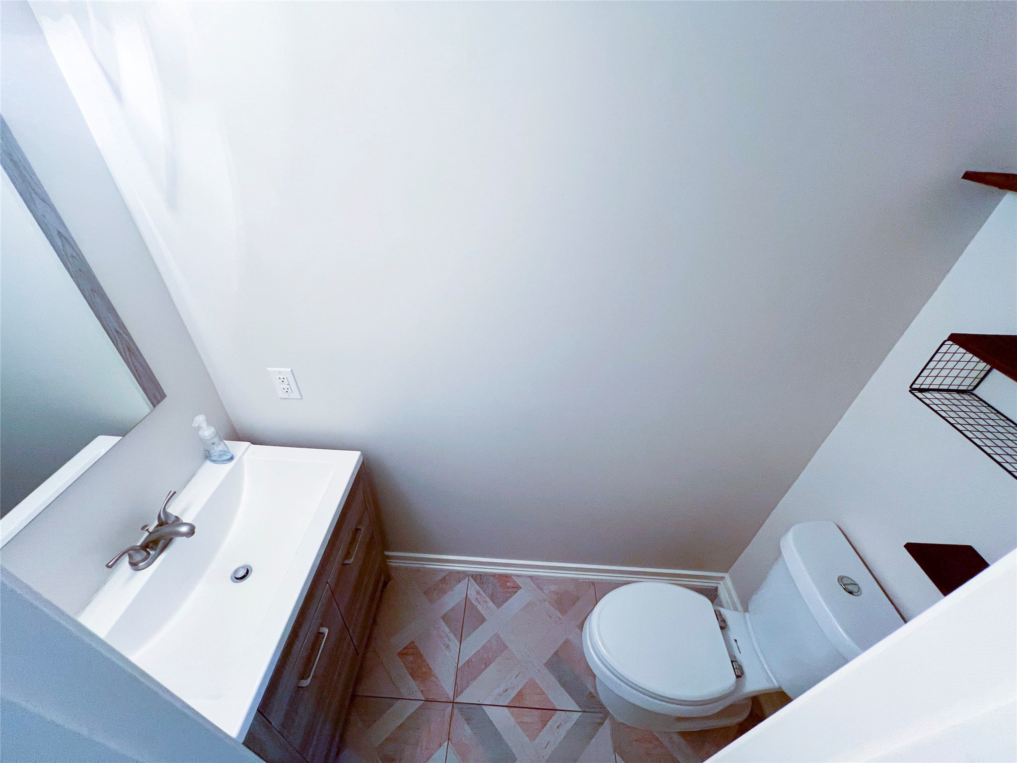 Conveniently located on the first floor, this stylish half bath offers modern fixtures and a sleek design, perfect for guests.