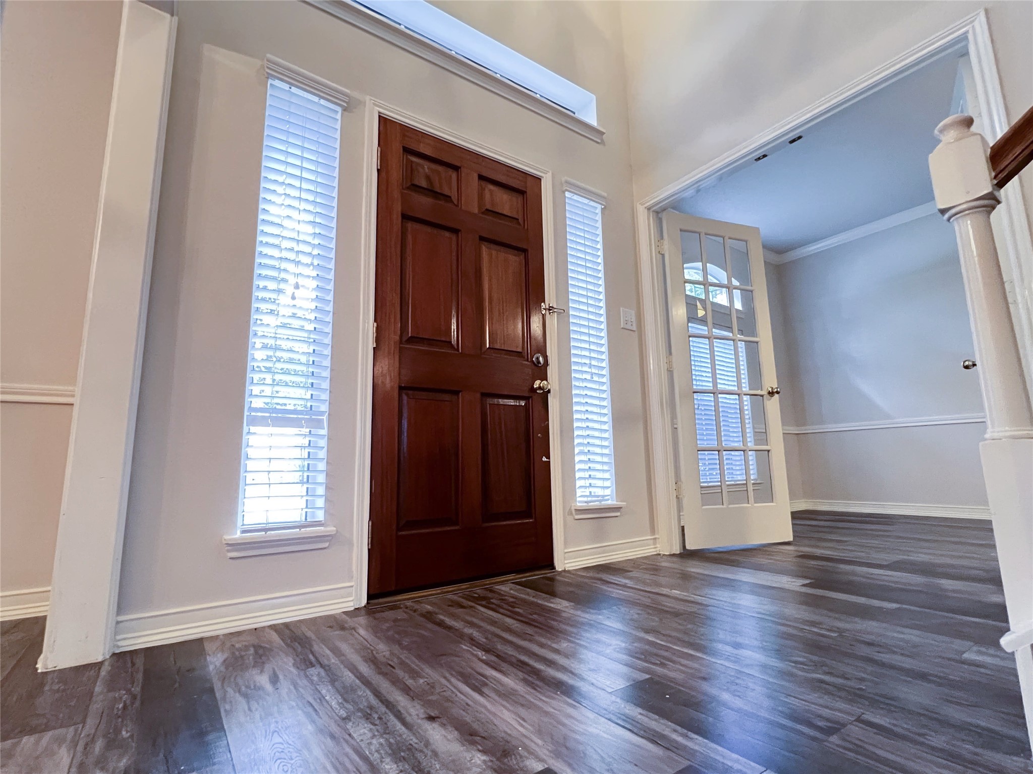 Step into elegance with this inviting entryway, featuring rich floors, abundant natural light, and a welcoming atmosphere that sets the tone for the rest of the home. Step into elegance with this inviting entryway, featuring rich floors, abundant natural light, and a welcoming atmosphere that sets the tone for the rest of the home.