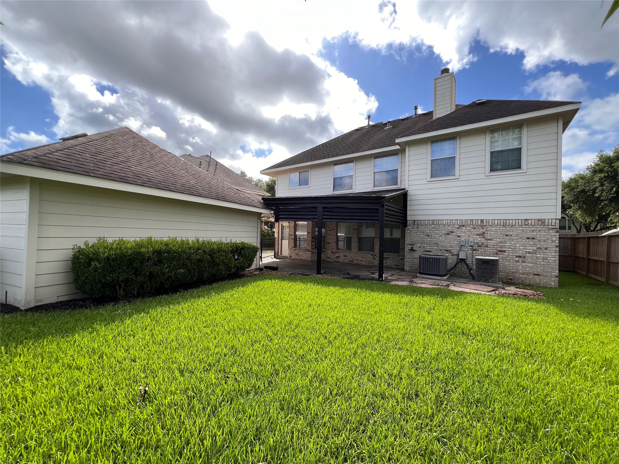 Experience serene outdoor living with this charming home's expansive backyard, featuring a covered patio perfect for relaxation and entertainment.