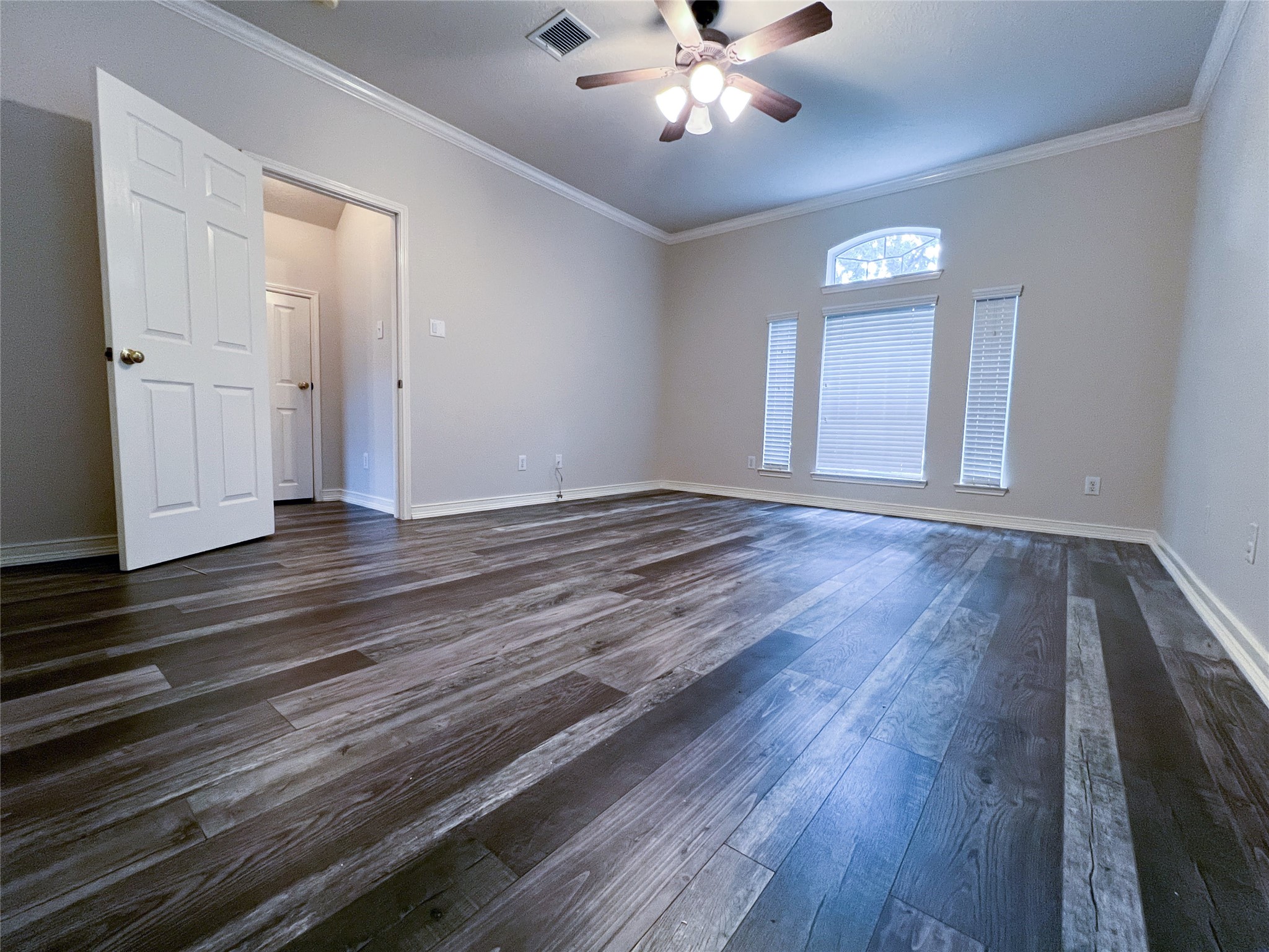 Experience the convenience and comfort of a spacious primary bedroom located on the first floor, featuring elegant flooring and abundant natural light.
