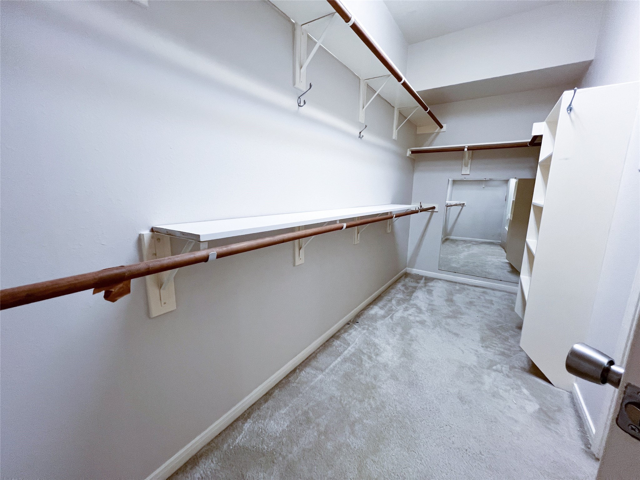 Experience the convenience and luxury of a spacious primary walk-in closet located on the first floor, designed for optimal organization and style.