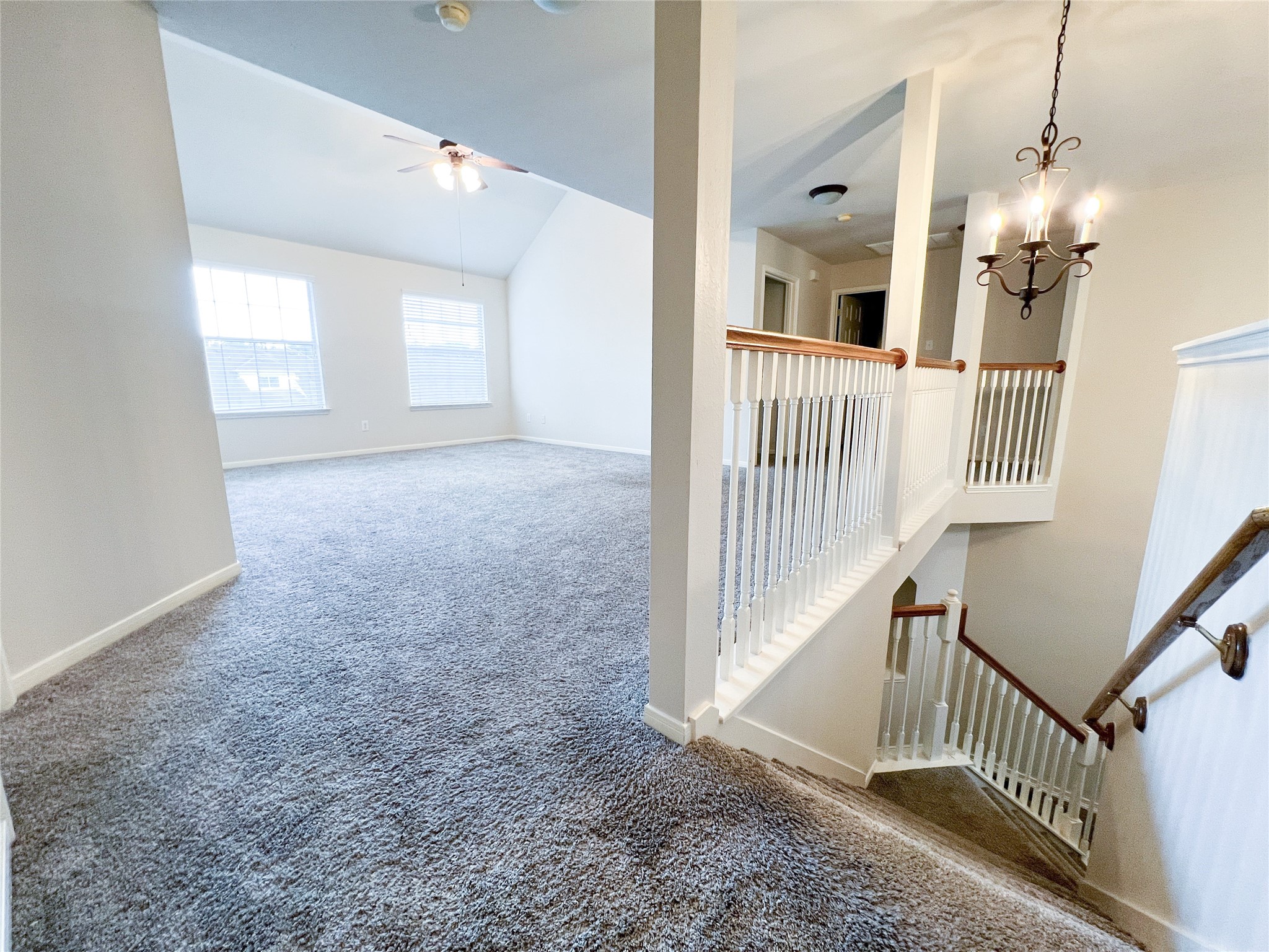 This inviting second-floor space boasts plush carpeting, elegant railing details, and abundant natural light, creating a perfect blend of comfort and style.