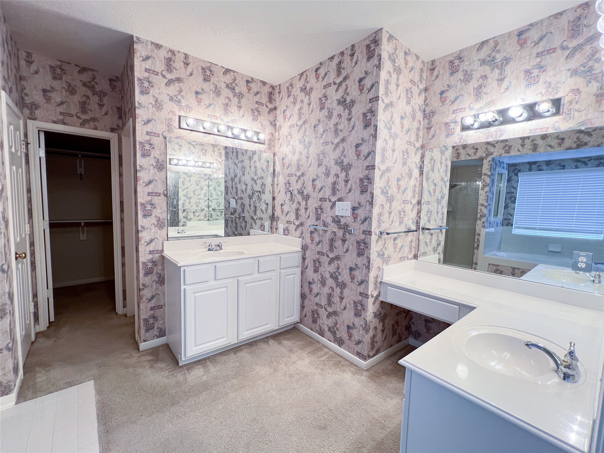 Experience the comfort and convenience of a spacious first-floor primary bathroom, complete with elegant dual vanities and ample storage.