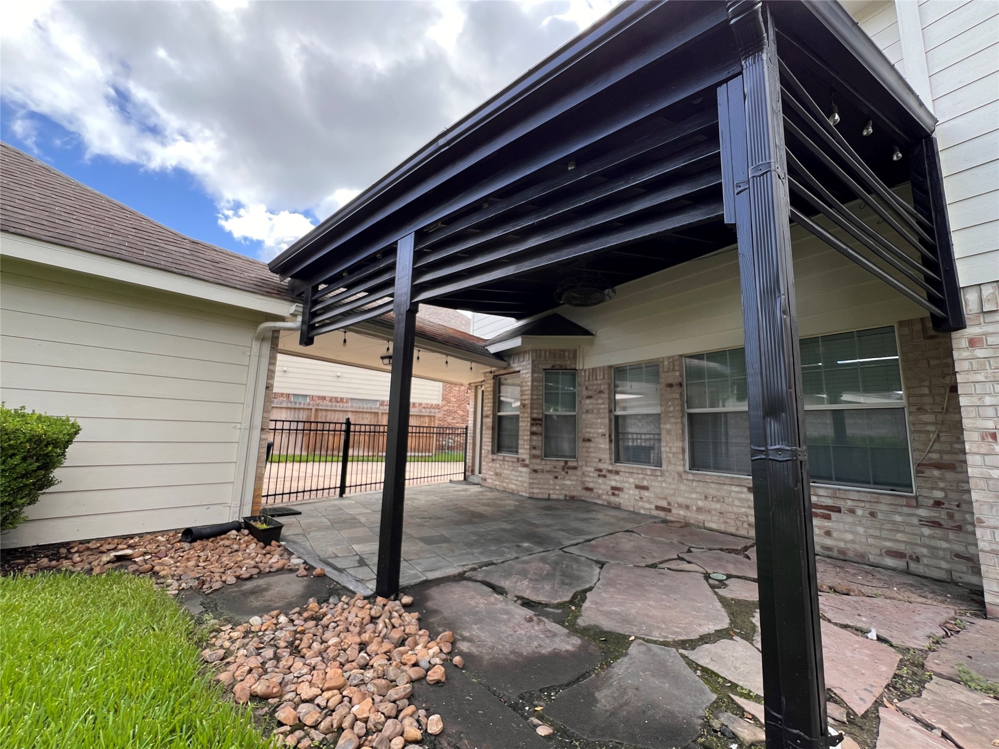Enjoy outdoor living with this charming covered patio, perfect for relaxing or entertaining in style.