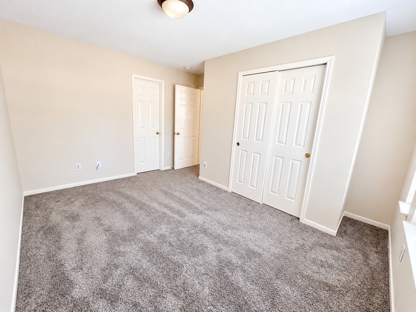 Discover the cozy charm of this second-floor bedroom, featuring plush carpeting and ample closet space for comfortable living.