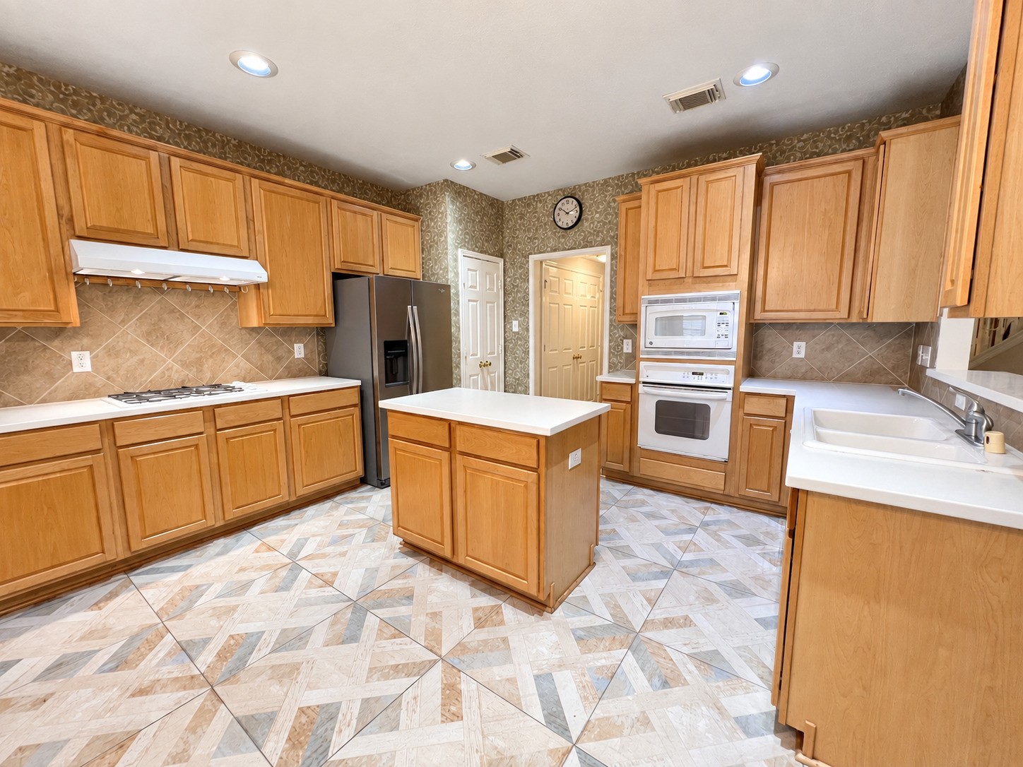 Spacious and inviting, this kitchen features modern appliances, ample cabinetry, and a central island, perfect for culinary creativity and gathering with loved ones.