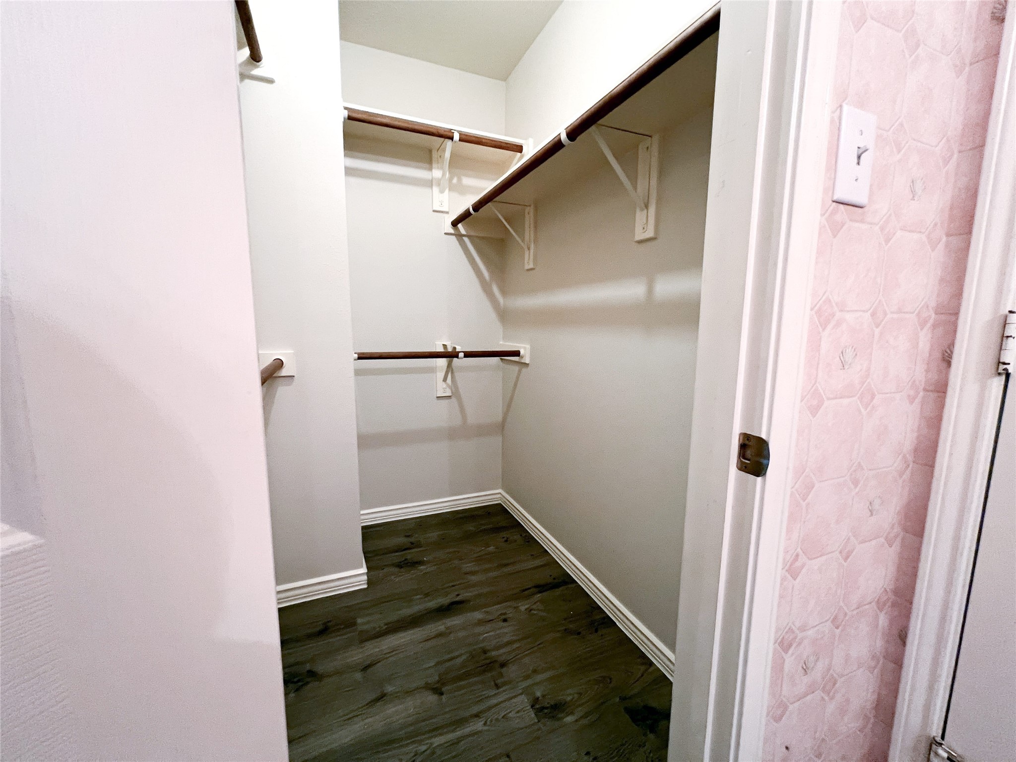 Step into luxury with this spacious walk-in closet, seamlessly connected to the bathroom for ultimate convenience and style.