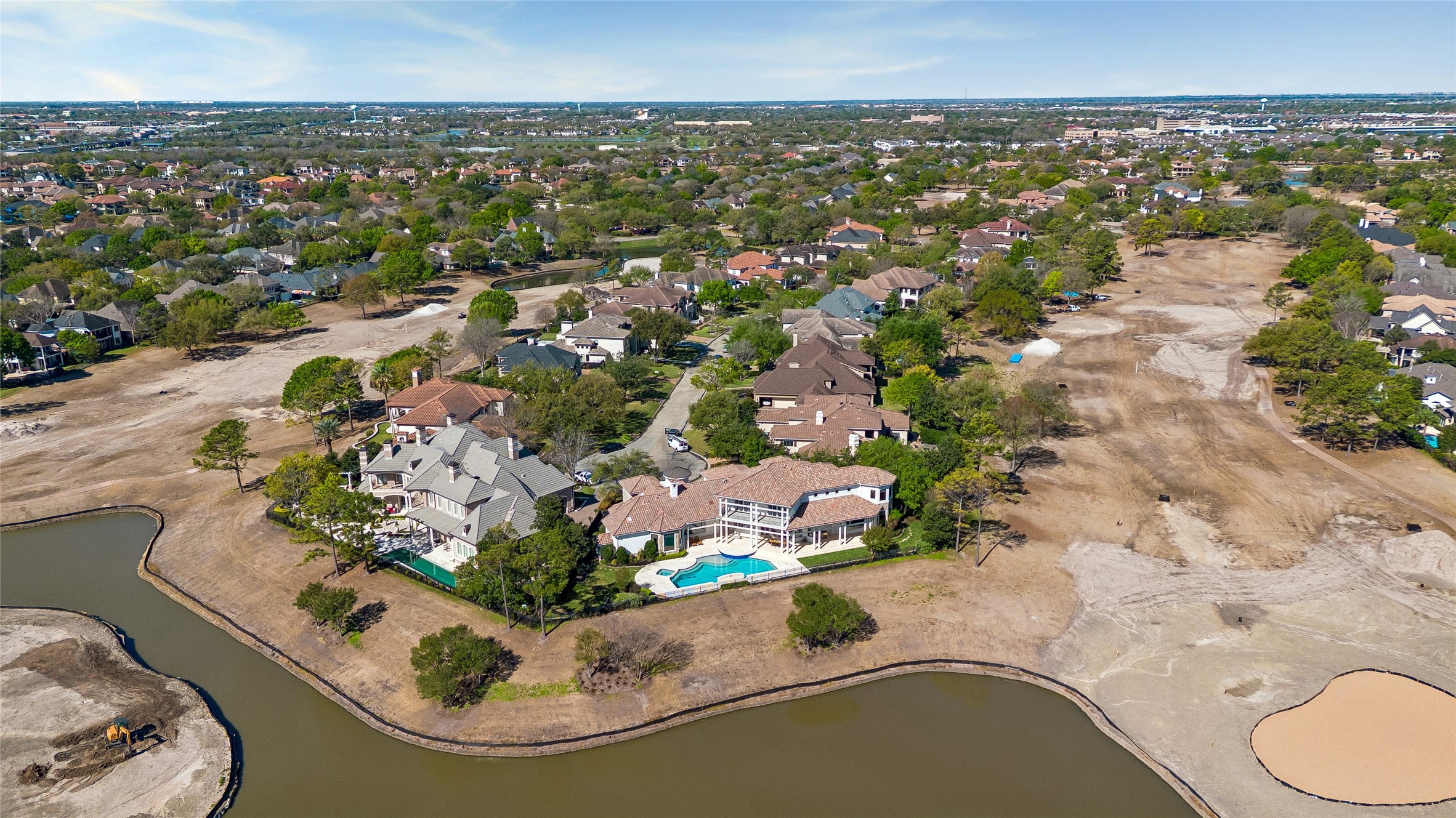 AERIAL VIEW OF THE MAGNIFICENT CUL-DE-SAC LOT - 240 feet bordering a lake and the Royal Oaks CC golf course