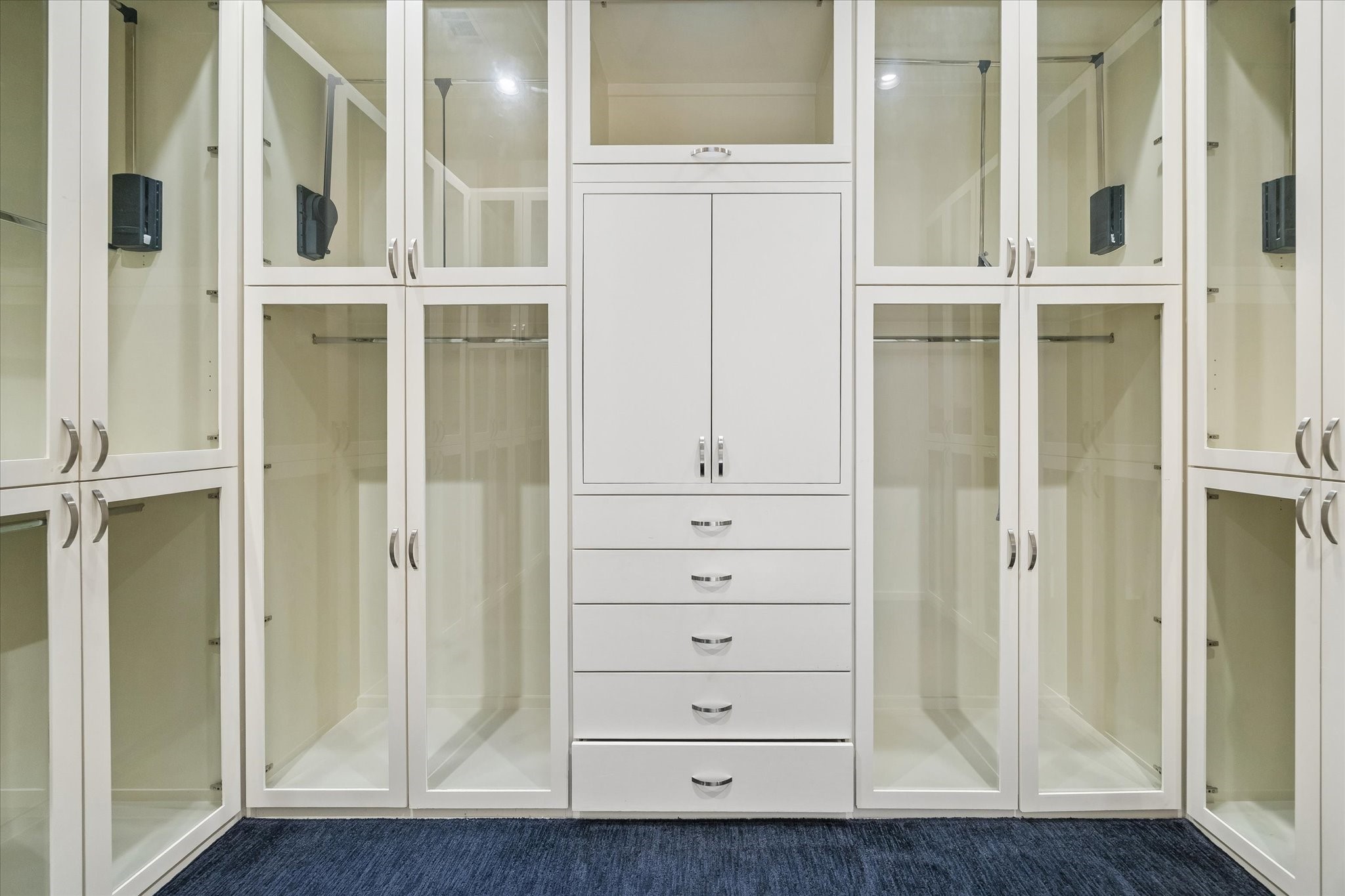 ONE OF TWO LARGE PRIMARY BEDROOM SUITE WALK-IN CLOSETS - this one fitted with glazed-insert doors to protect clothing in the hanging spaces, plus built-in storage drawers and cabinetry