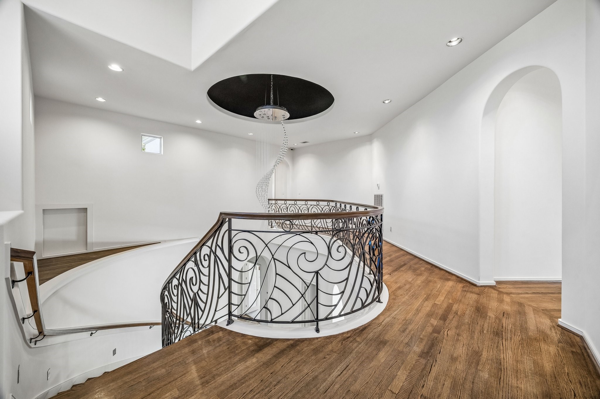 SPACIOUS HALLWAY UPSTAIRS - leading to 3 ensuite bedrooms and a large private multi-purpose room ideal for play, dancing, crafts, exercise & more - handsome hardwood flooring, recessed lighting, view of dramatic chandelier over the stairway
