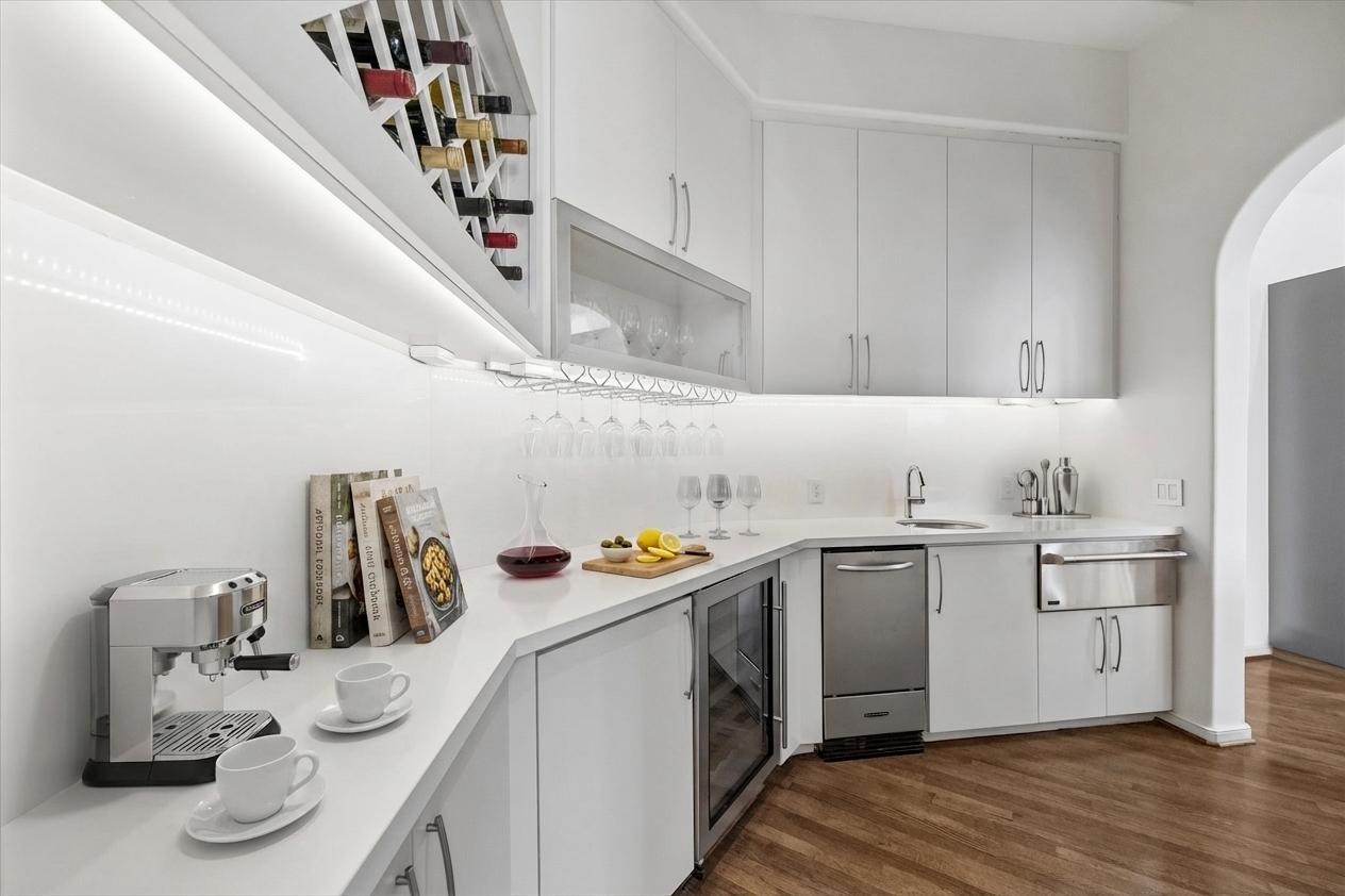 VIRTUALLY STAGED - wet bar in convenient location between the dining room and kitchen - an ideal spot for easy entertaining - already features a built-in wine chiller, icemaker and warming drawer