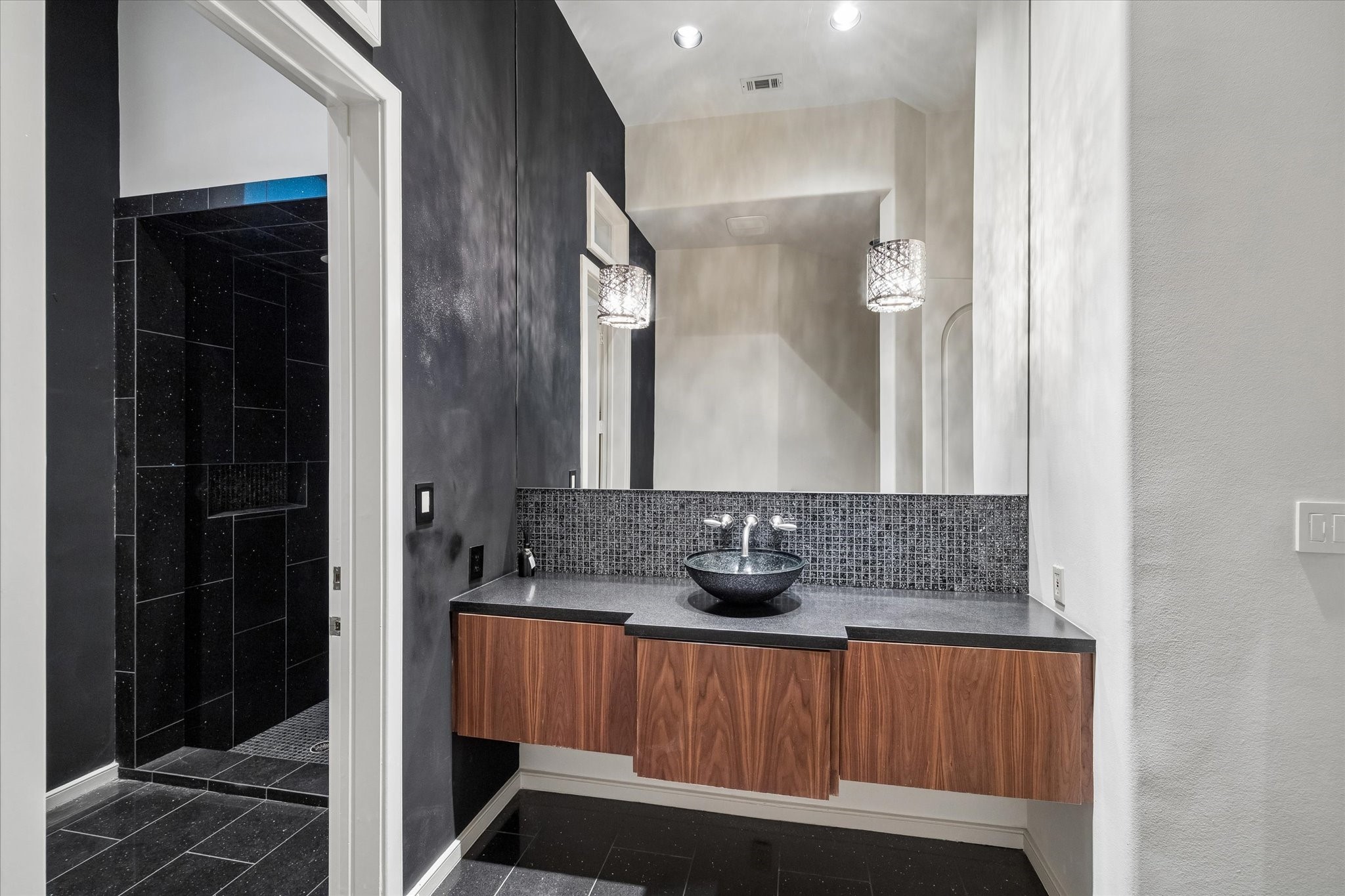 ELEGANT FULL GUEST BATH CONVENIENTLY LOCATED NEAR THE GAMEROOM AND DEN/GUEST BEDROOM - access door to the terrace and pool/spa - vessel sink with mirror-mounted sconces, shower and cabinetry for towels, et cetera