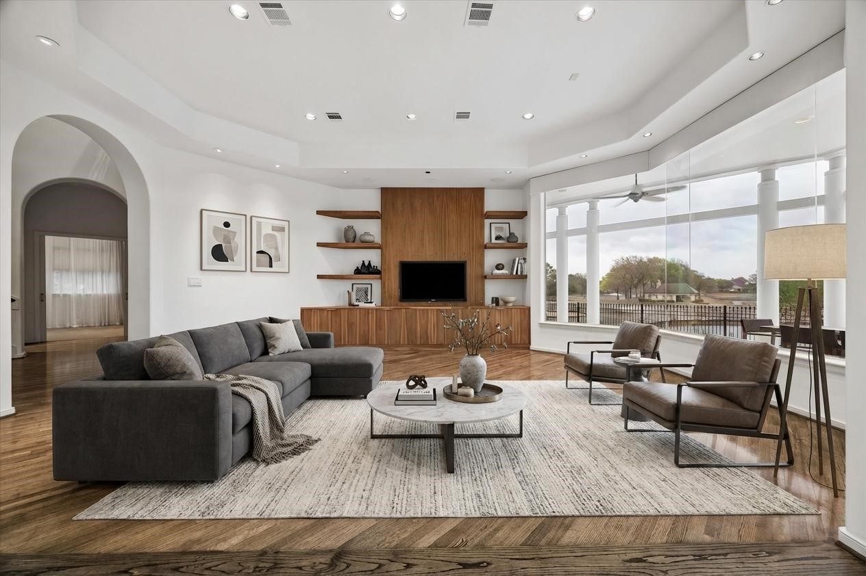 VIRTUALLY STAGED - dramatic family room is comfortably furnished for easy living and entertaining - ideal flow between the open family room and spacious island kitchen - read and relax in style and enjoy the views over the lake and fairways