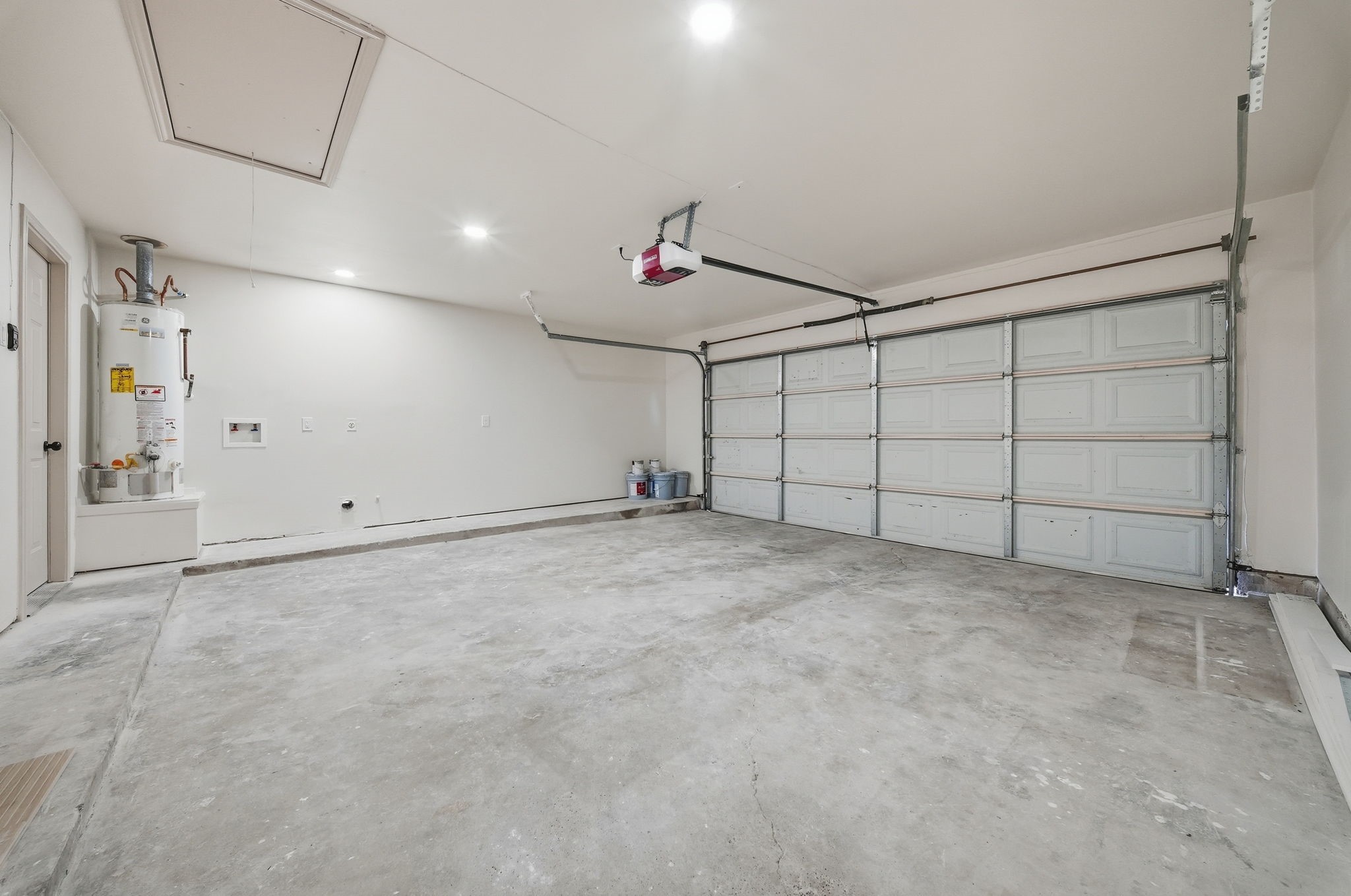Spacious two-car garage with ample lighting, perfect for storage or a workshop setup.