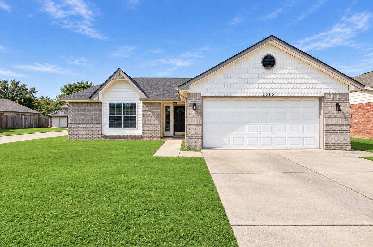Charming single-story home with a welcoming curbside view, featuring a spacious two-car garage and a beautifully manicured lawn in a serene neighborhood.