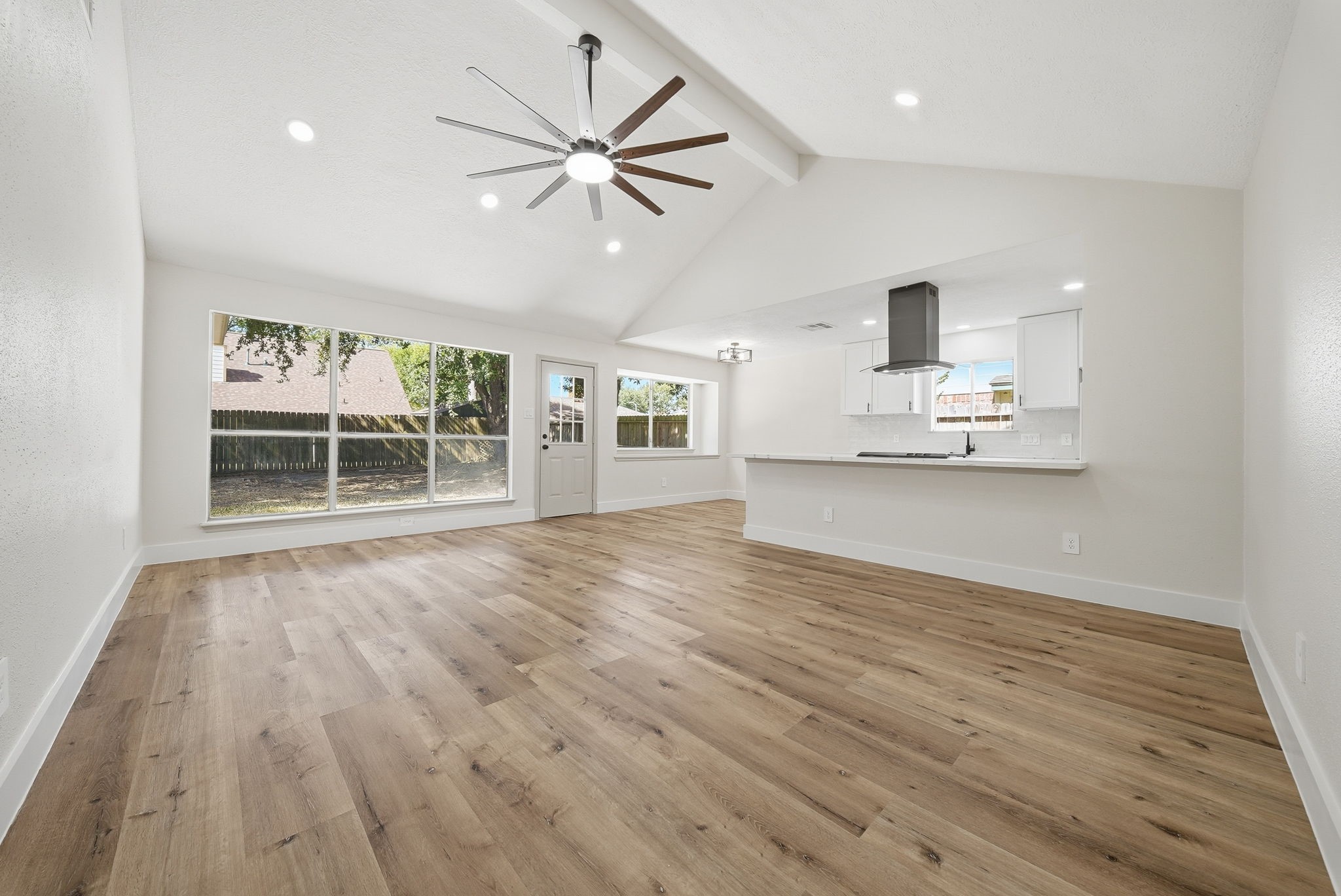 The open-concept and recess lighting through layout seamlessly connects to a modern kitchen, perfect for entertaining.
