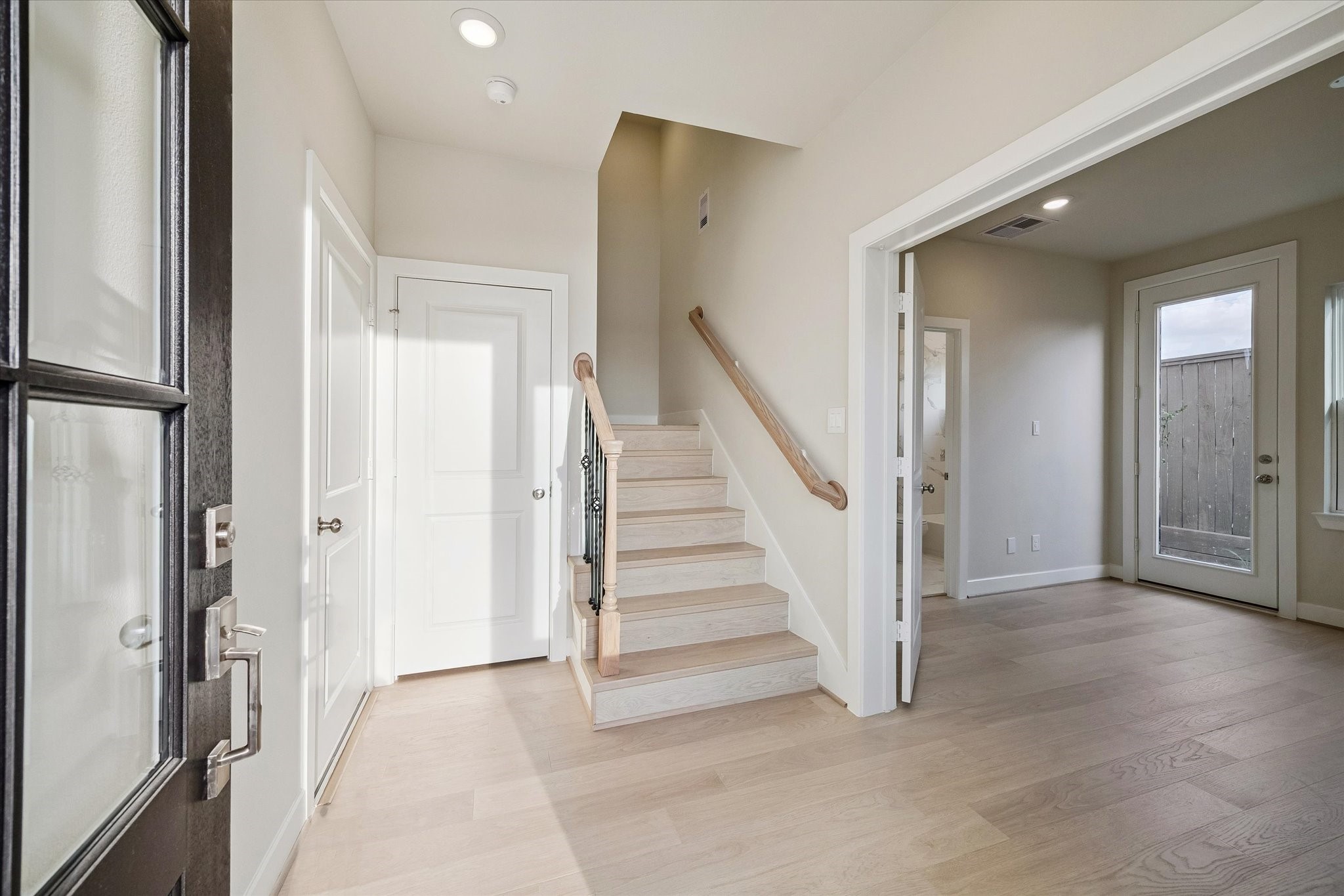 Welcome to 3119 Hicks Street! There's a coat closet in the foyer and to the right is the first secondary bedroom with it's own bathroom.
