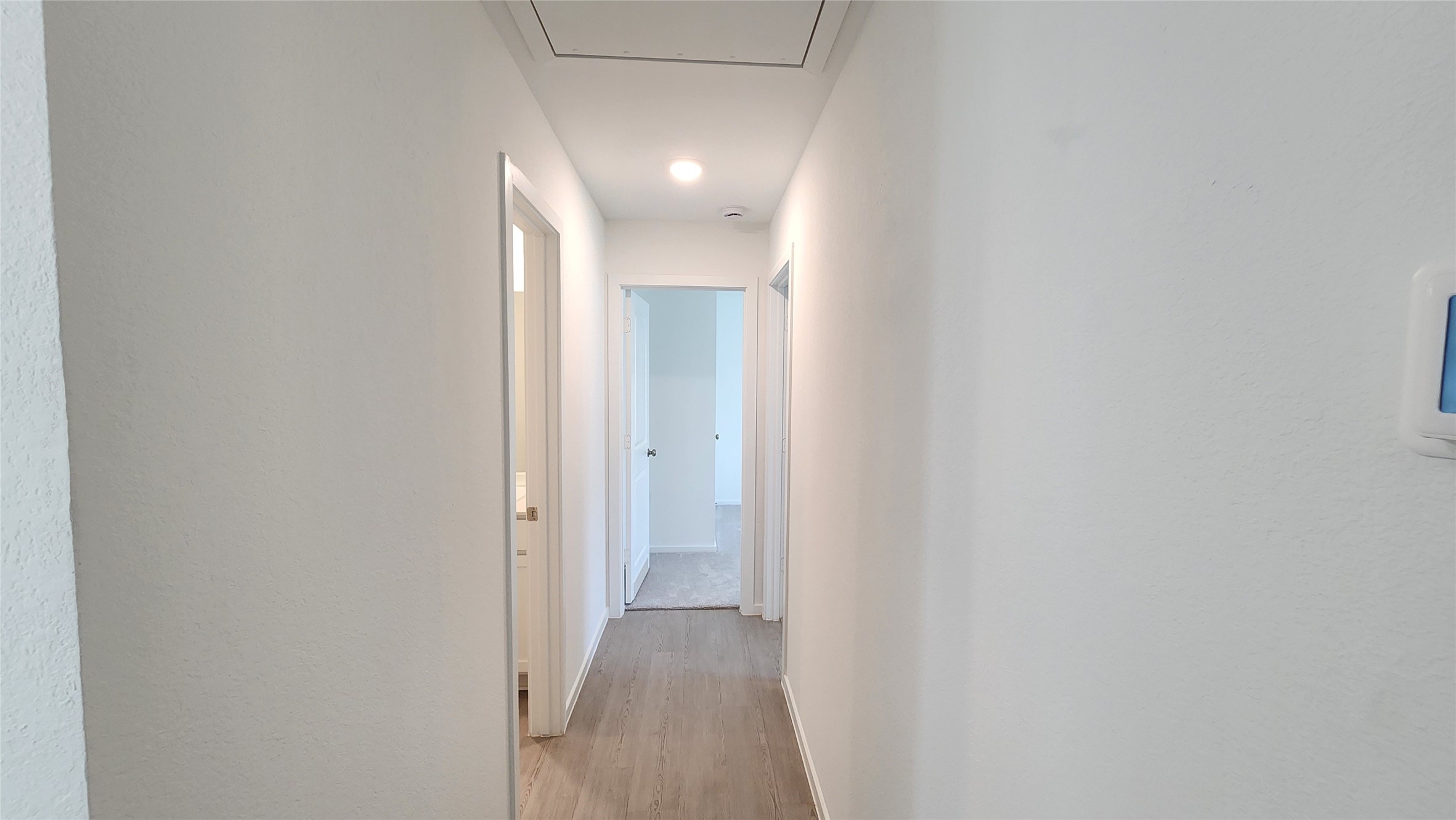 Hallway to 2 additonal bedrooms and hall bathroom