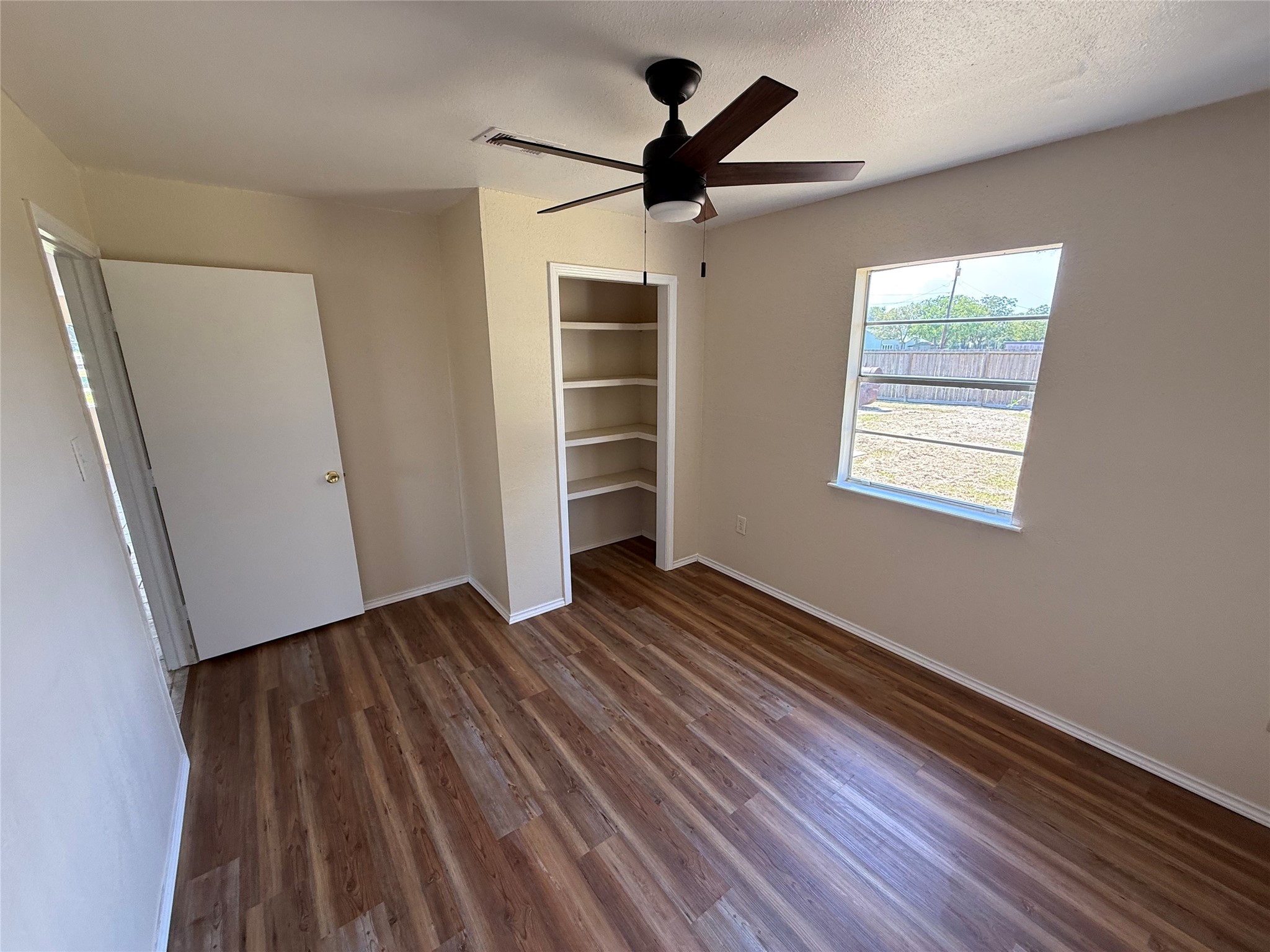 Alternate room view highlighting closet storage and open shelving.