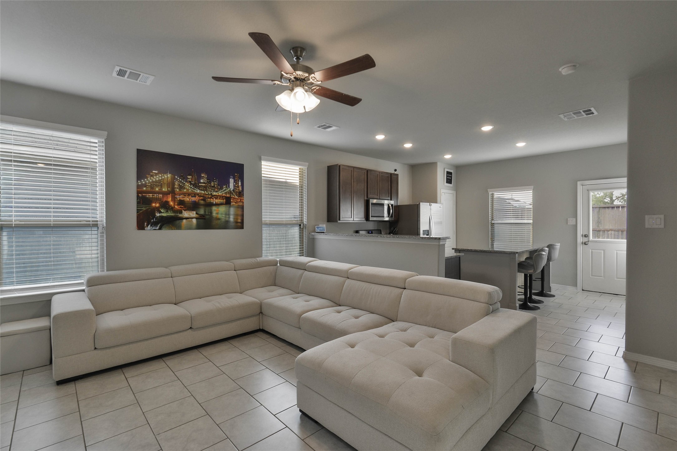 WALK into a spacious Living room overlooking the Kitchen with Tile flooring throughout !