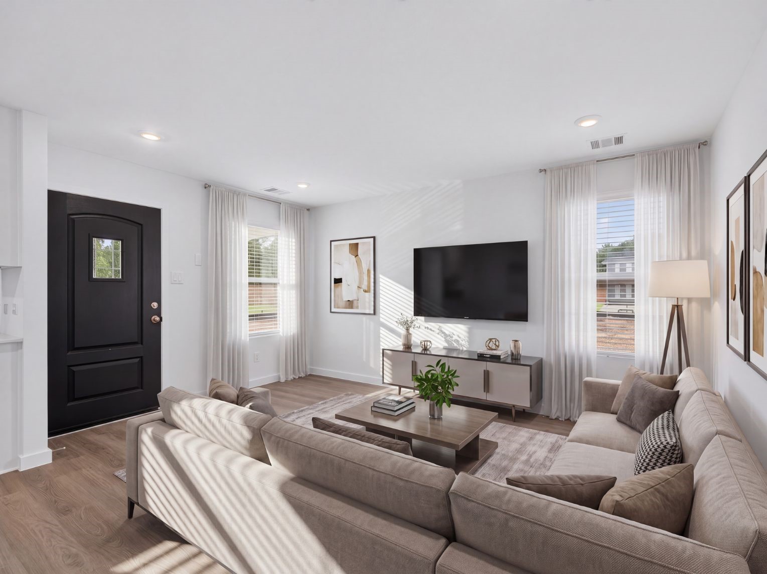 Bright living area with wood-look floors, two windows, and a glass-paned front door. The open wall layout leaves plenty of room to arrange furniture.
This photo has been digitally staged to illustrate the possibilities of the home's aesthetic and potential design. Some furnishings and dcor shown are for visual inspiration.