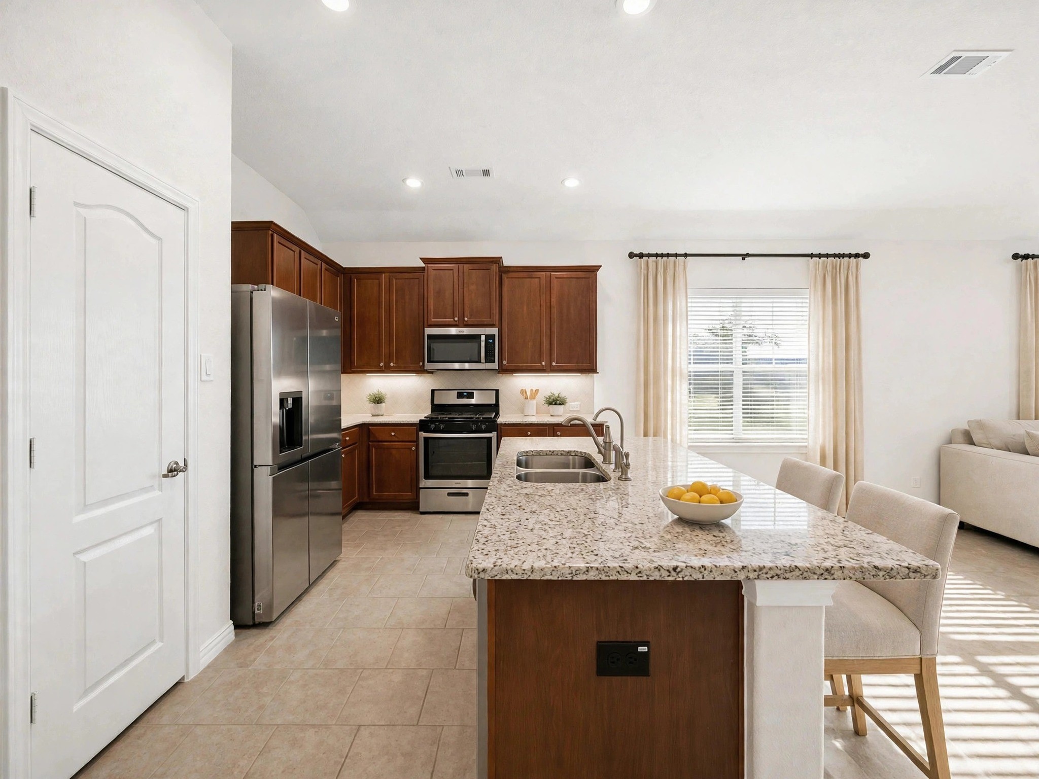 The kitchen features a center island, ample cabinetry, and an open connection to the living area. (Virtaully staged) The kitchen features a center island, ample cabinetry, and an open connection to the living area. (Virtaully staged)