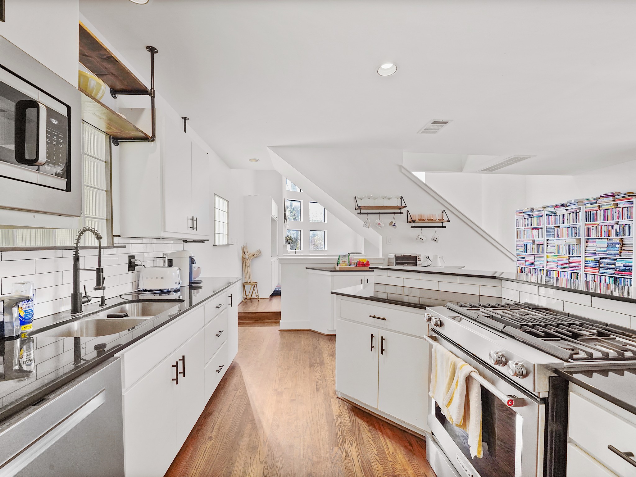 This modern kitchen dazzles with sleek stainless steel appliances, seamlessly blending style and functionality for a dream culinary experience.