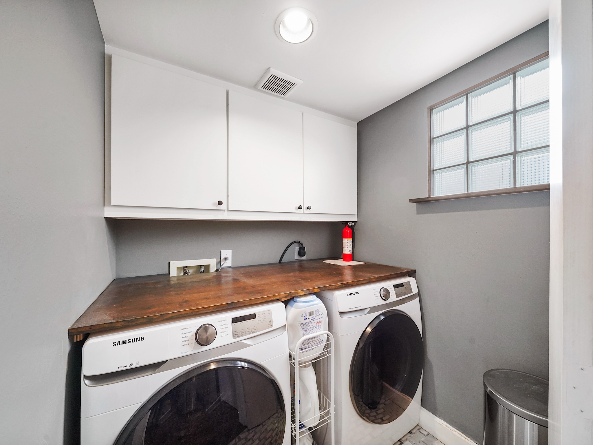 This spacious and efficient laundry room offers ample storage and a perfect setup for all your chores.