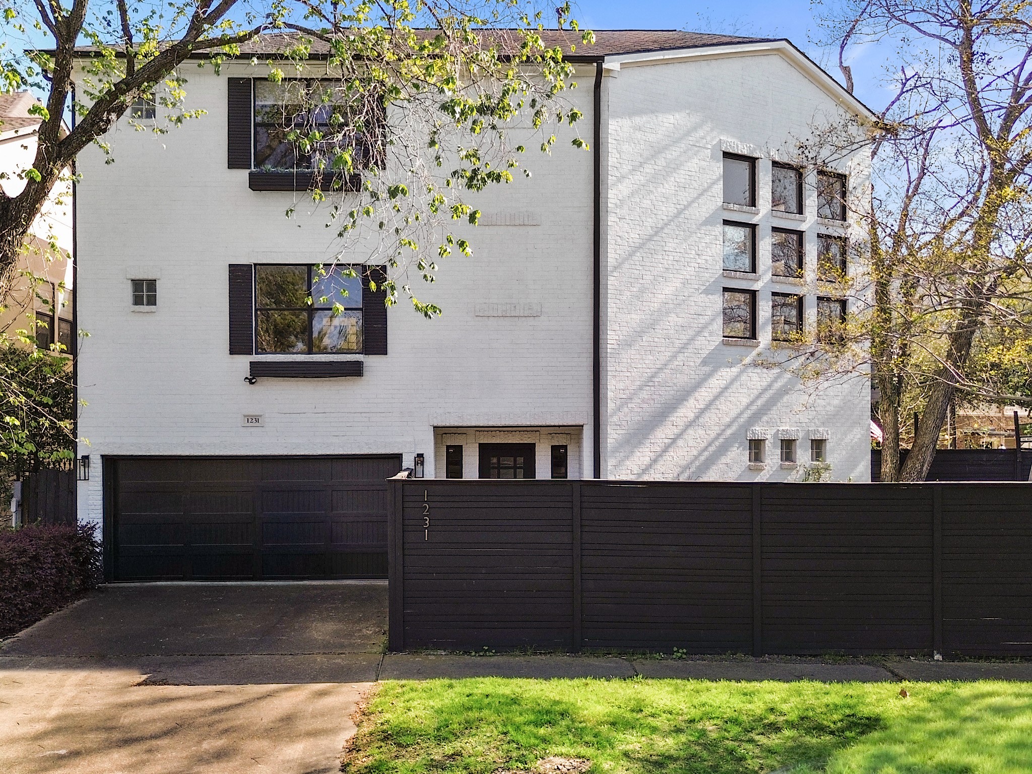 Welcome to 1231 Jackson Blvda stunning, modern home with a sleek white facade, stylish black accents, and abundant natural light, offering both elegance and privacy in a desirable location.