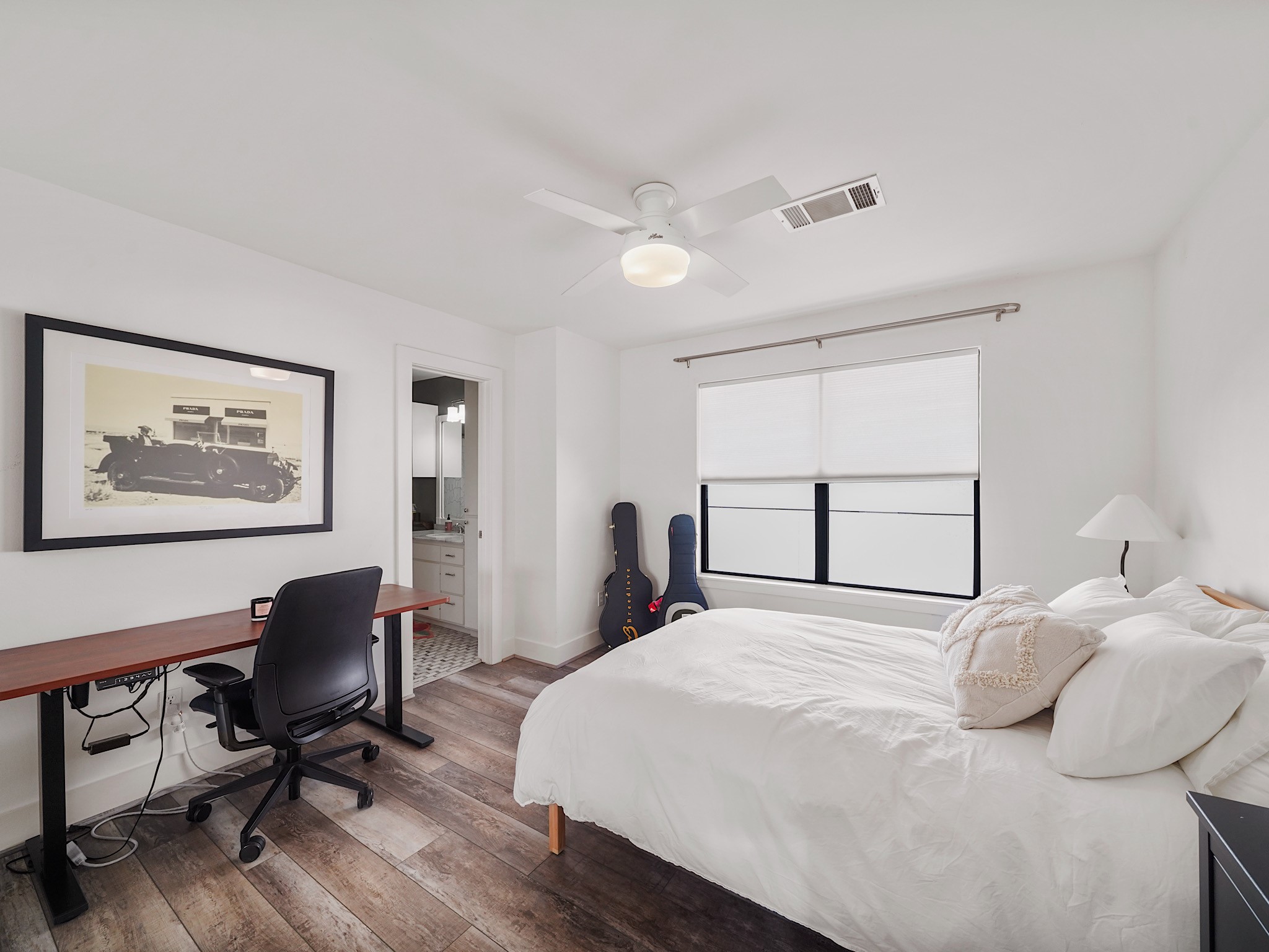 This bright and spacious secondary bedroom, complete with an attached bath, offers comfort and style for a perfect retreat.