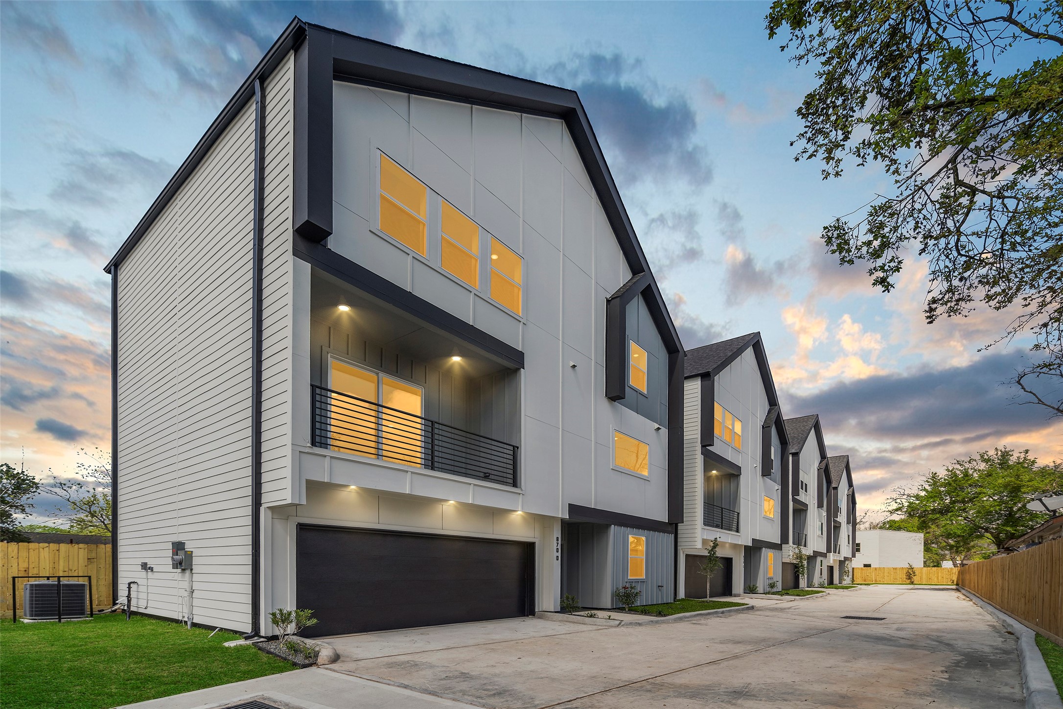 Welcome to your home at 870 W. Little York Road, #C.  This modern multi-story townhouse has a sleek design, featuring large windows and a balcony.  the unit has an attached garage and its situated on a quiet, well-maintained street, perfect for comfortable urban living.