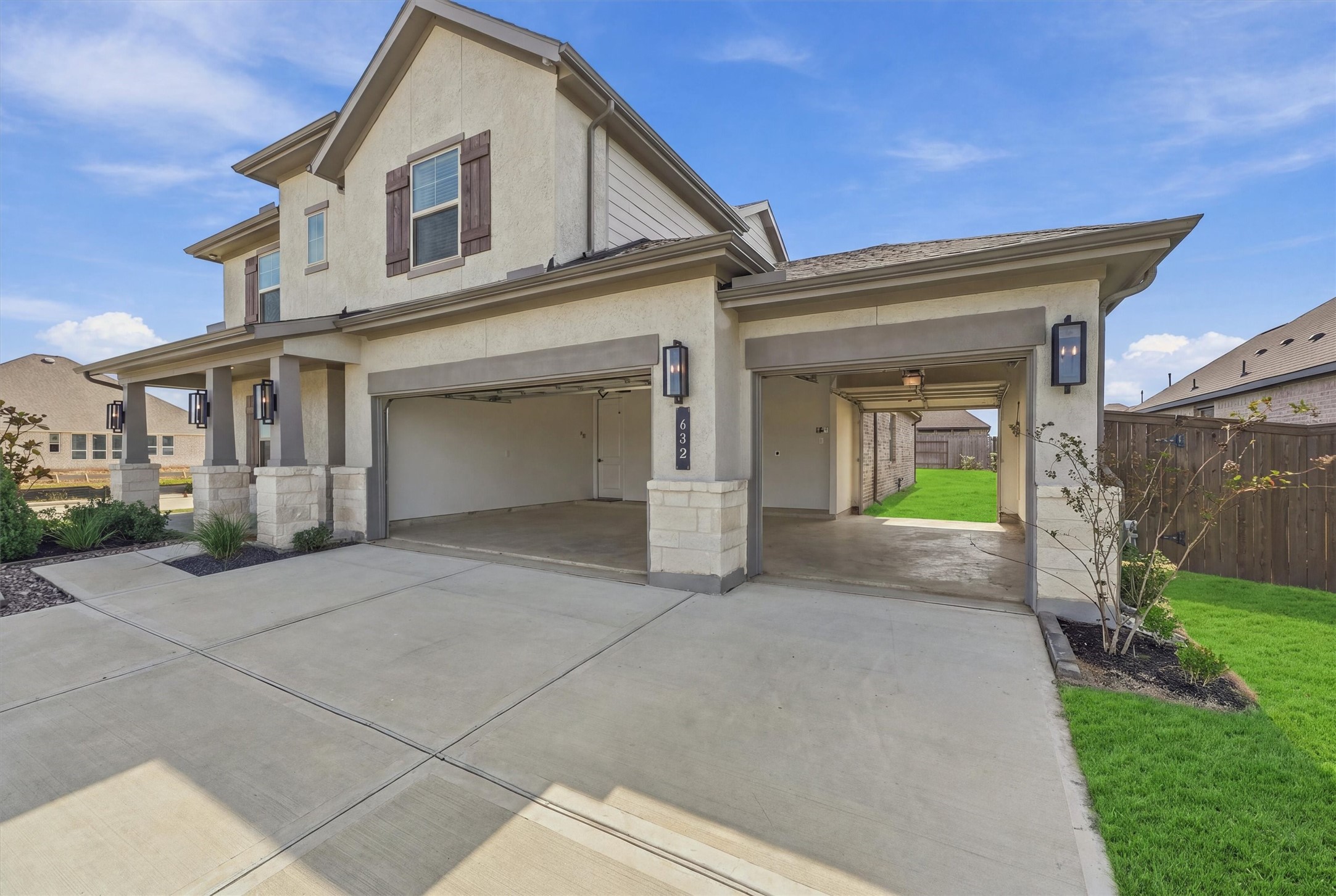 Three bays, including a drive-through bay with a rear door to the backyard for mowers, toys, or a workshop. Three bays, including a drive-through bay with a rear door to the backyard for mowers, toys, or a workshop.