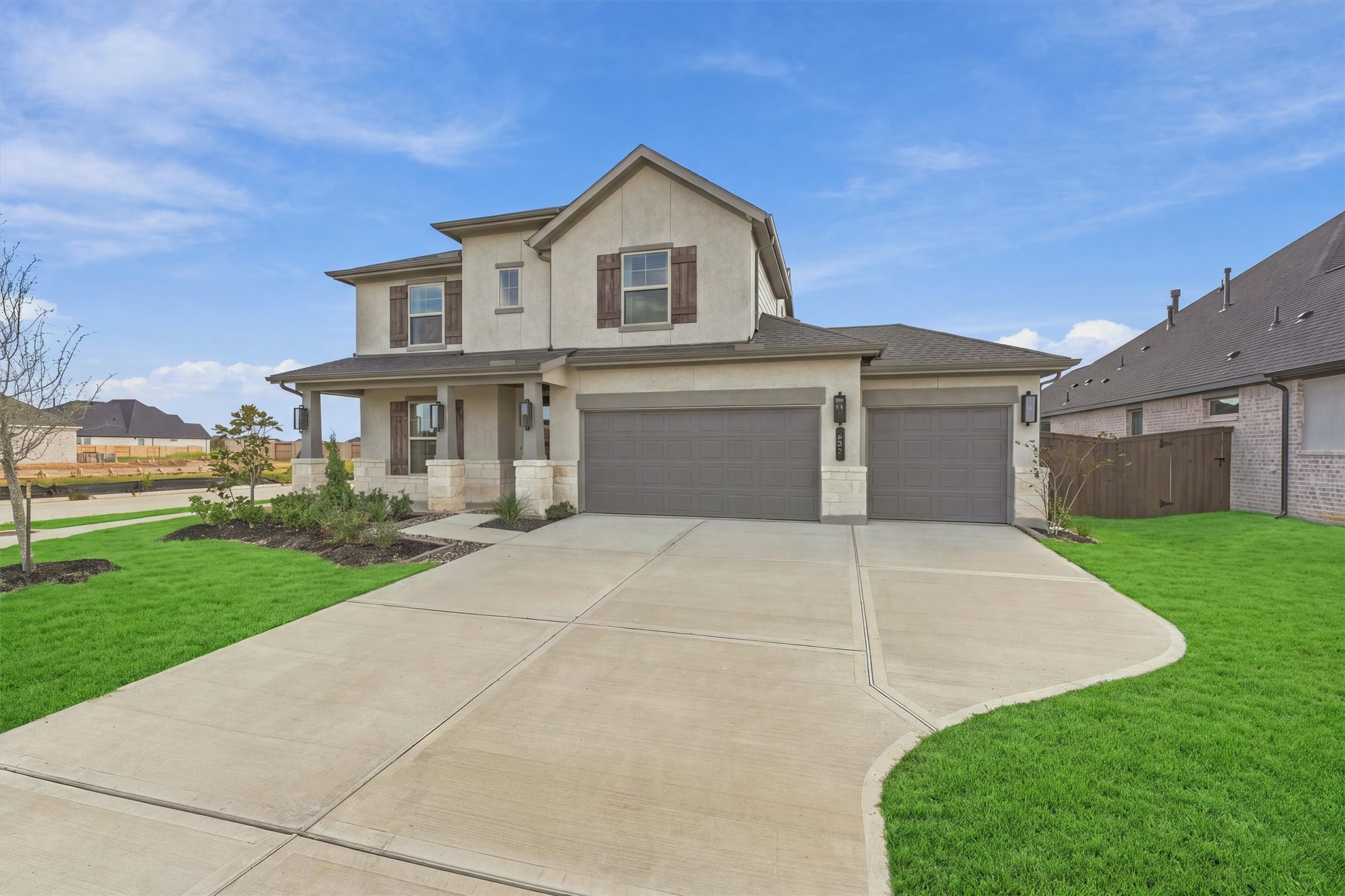 A sweeping driveway leads to the three-car garage, framed by manicured landscaping and a generous front lawn. A sweeping driveway leads to the three-car garage, framed by manicured landscaping and a generous front lawn.