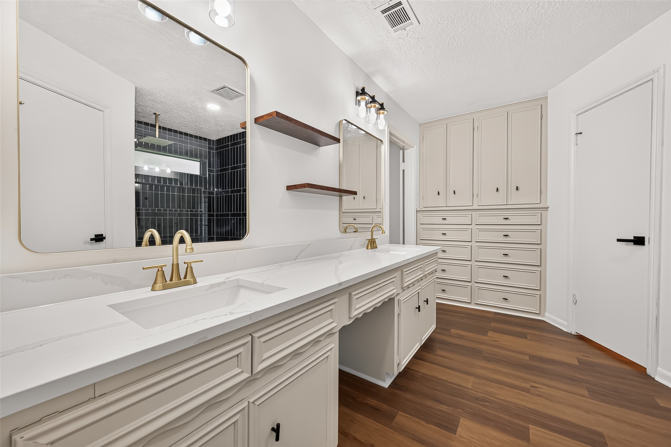 Primary bathroom features
separate dual closets with
additional built-in storage
