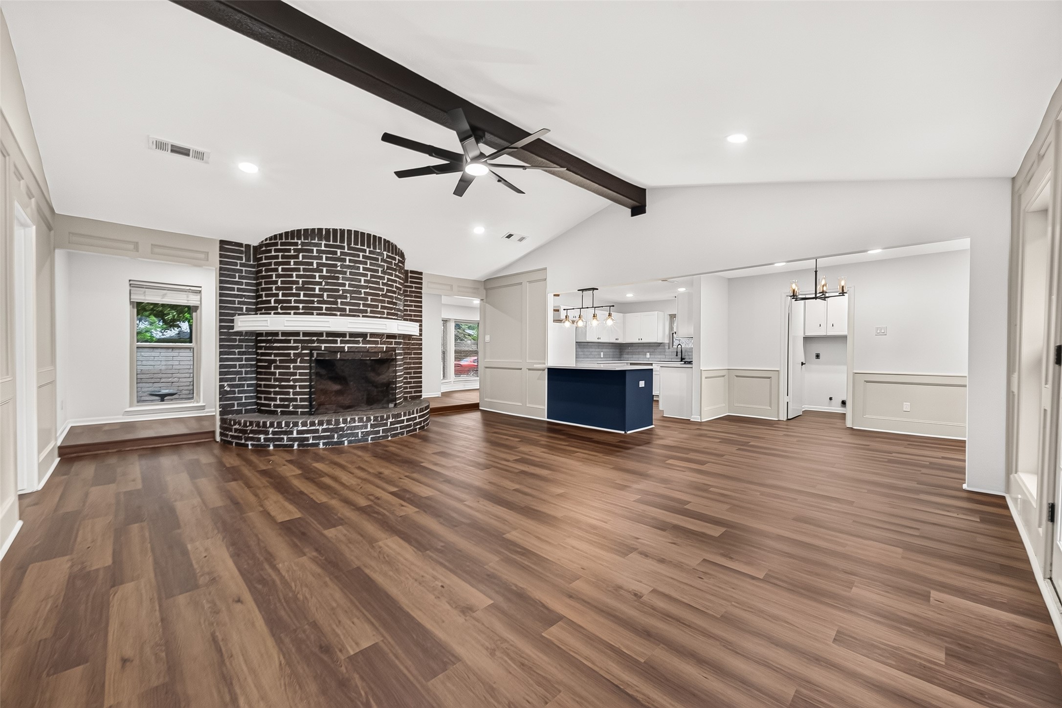 Bright open-concept layout connecting the living room, kitchen, and dining space