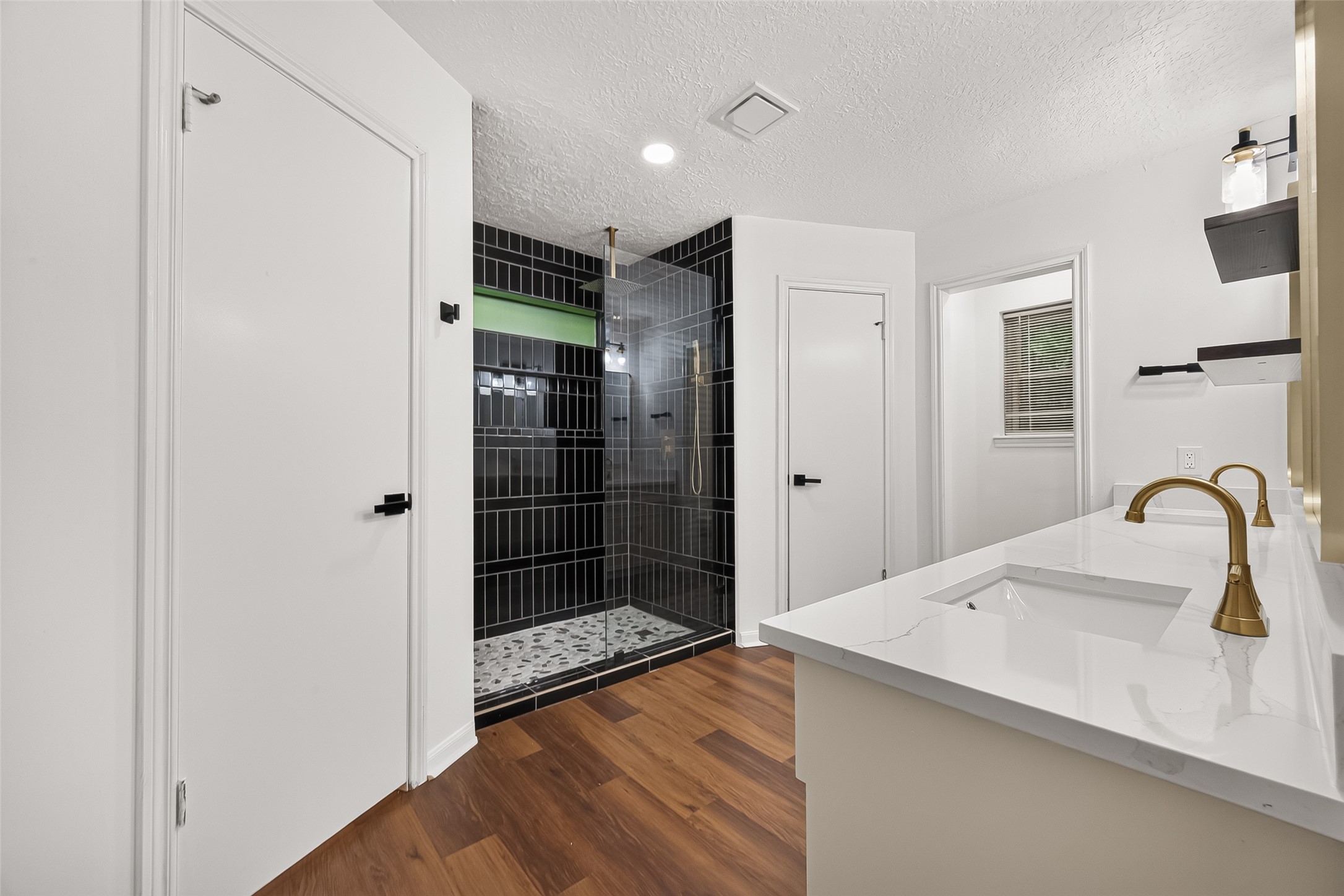 Modern primary bathroom offering
a brand-new walk-in shower and
dual walk-in closet