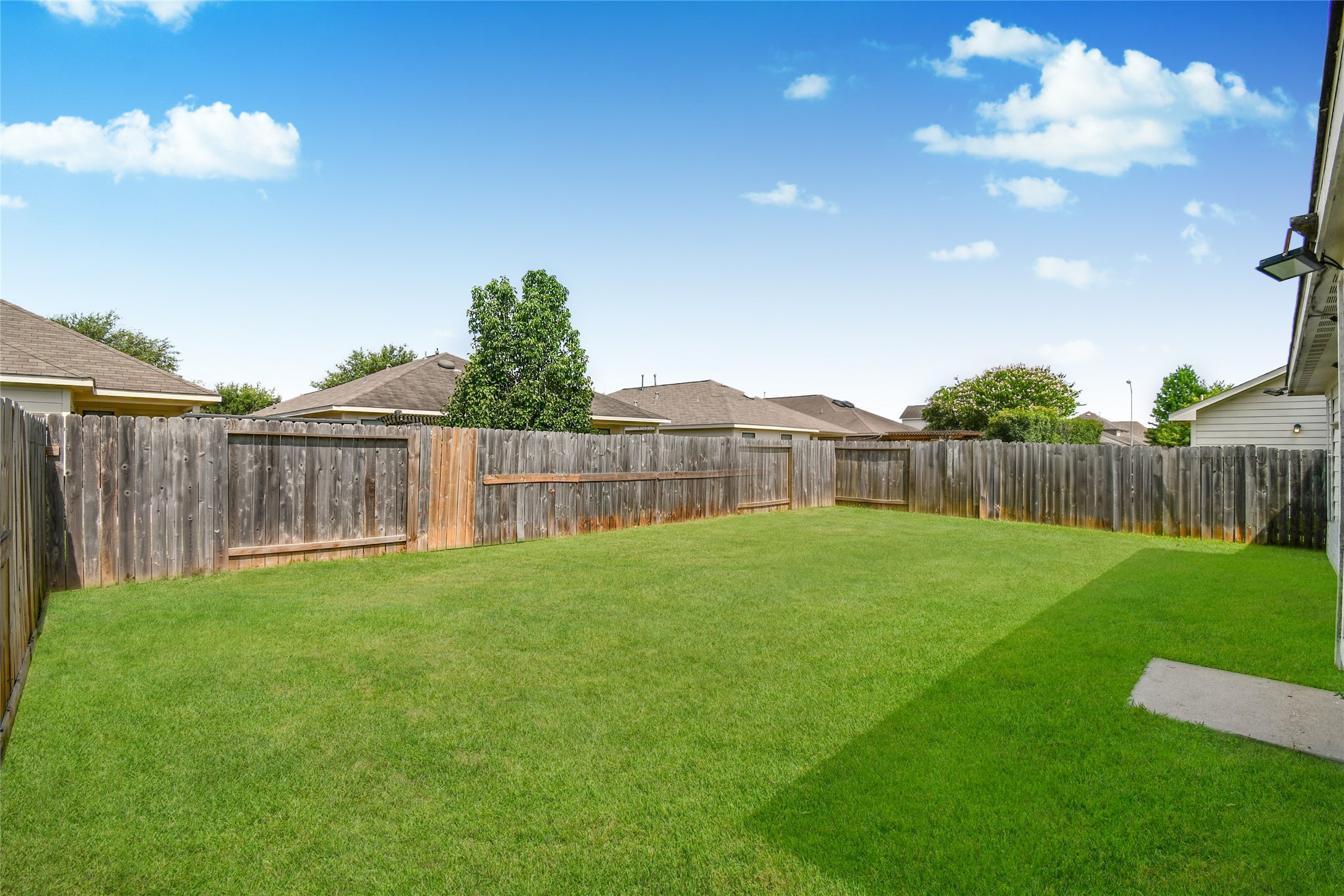 Spacious fenced backyard offering plenty of room to relax, entertain, or add your personal touch
